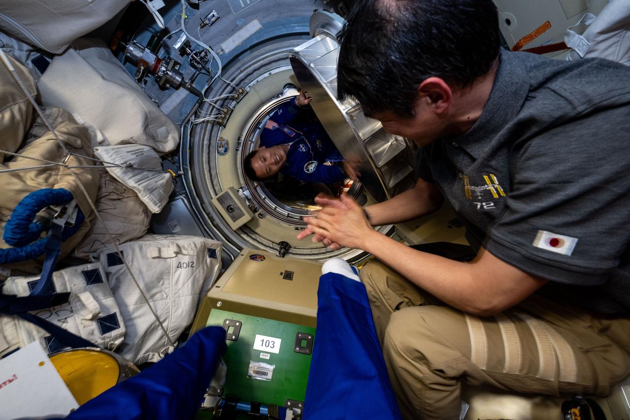 iss072e940001 (April 8, 2025) --- NASA astronaut and Expedition 72 Flight Engineer Jonny Kim is pictured before entering the International Space Station shortly after docking to the Prichal module aboard the Soyuz MS-27 spacecraft. Waiting to greet Zubritsky is Flight Engineer Takuya Onishi of JAXA (Japan Aerospace Exploration Agency), at right.