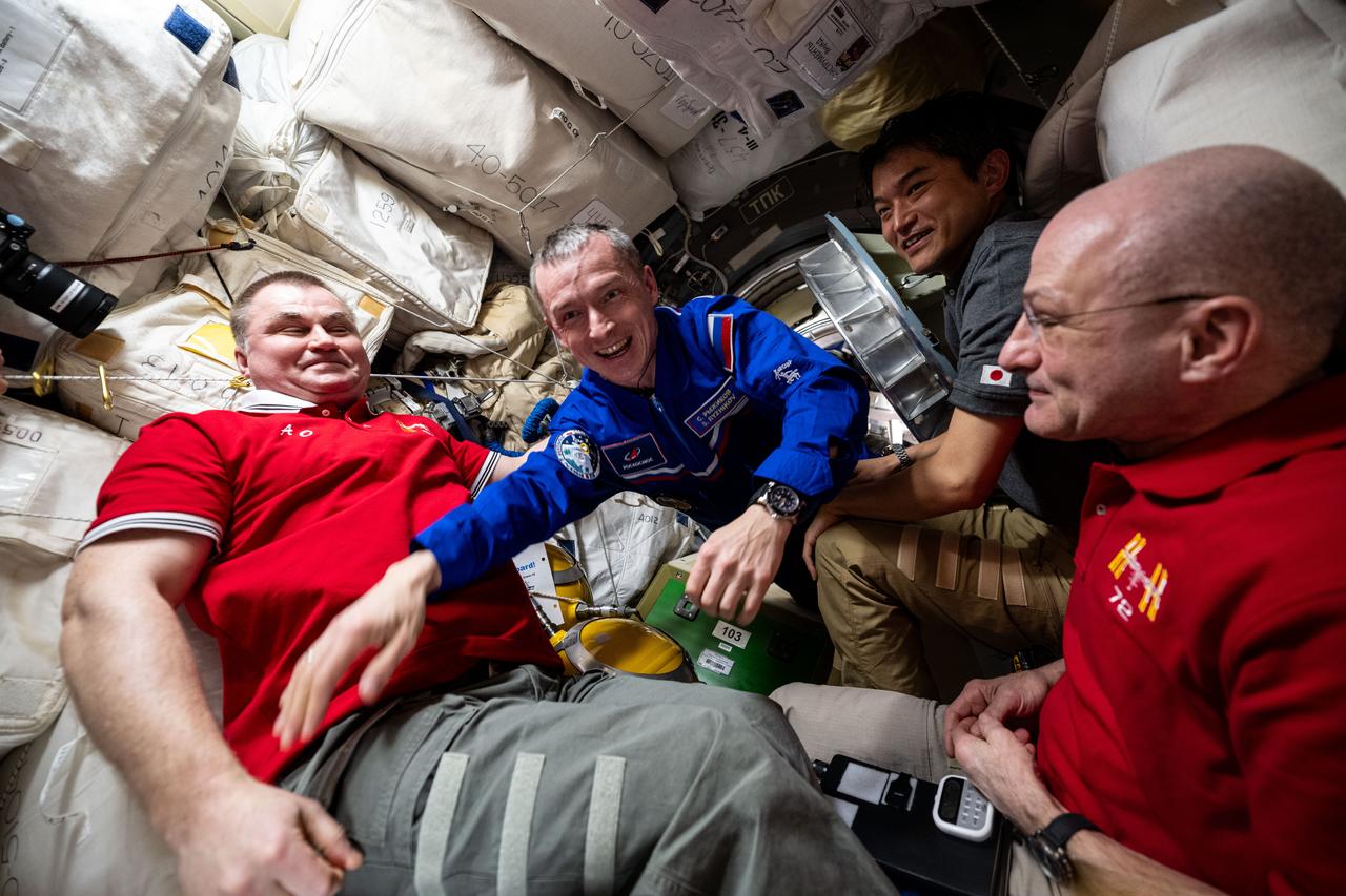 iss072e940013 (April 8, 2025) --- Roscosmos cosmonaut and Expedition 72 Flight Engineer Sergey Ryzhikov enters the International Space Station shortly after docking to the Prichal module aboard the Soyuz MS-27 spacecraft. Ryzhikov is greeted by station Commander Alexey Ovchinin of Roscosmos (left) and flight engineers Takuya Onishi of JAXA (Japan Aerospace Exploration Agency), at right, and Don Pettit of NASA (far right).