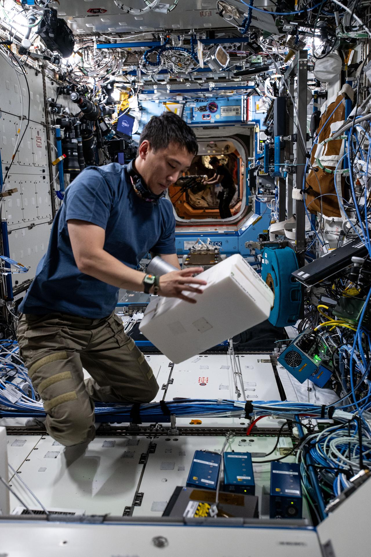 NASA astronaut and Expedition 72 Flight Engineer Jonny Kim installs experimental hydrogen sensors to test the advanced life support gear for longer calibration life and improved reliability aboard the International Space Station's Destiny laboratory module.