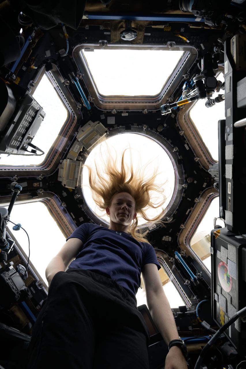 iss072e978930 (April 6, 2025) --- NASA astronaut and Expedition 72 Flight Engineer Nichole Ayers poses for a portrait inside the seven window cupola, the International Space Station's "window to the world," as the orbital outpost soared 263 miles above Russia near the Kazakhstan border.