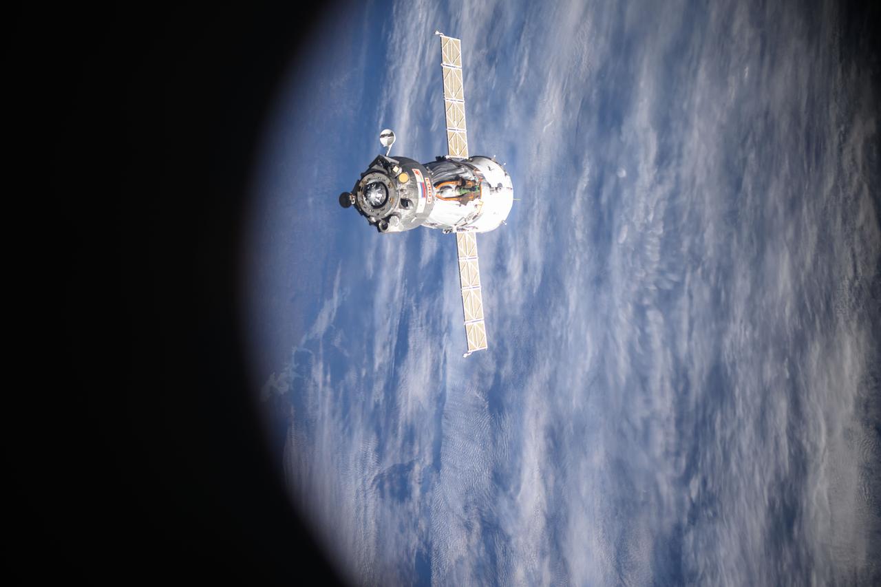iss073e0000056 (April 19, 2025) --- The Soyuz MS-26 spacecraft is pictured backing away from the International Space Station shortly after undocking from the Rassvet module. The Soyuz crew ship would parachute to a landing in Kazakhstan about three hours later returning NASA astronaut Don Pettit and Roscosmos comonauts Alexey Ovchinin and Ivan Vagner back to Earth after a 220-day space research mission.