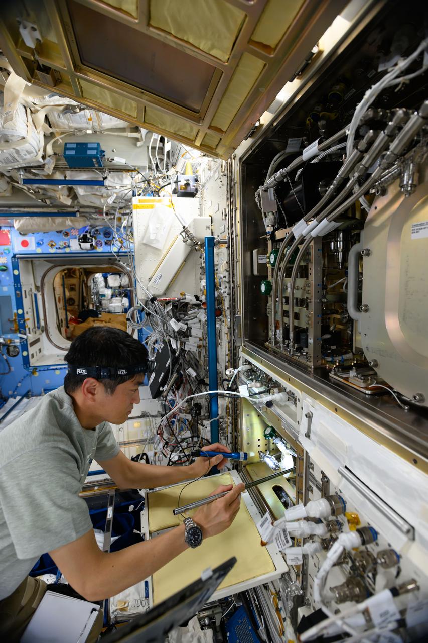 iss073e0000313 (April 21, 2025) --- JAXA (Japan Aerospace Exploration Agency) astronaut and Expedition 73 Commander Takuya Onishi inspects science hardware inside the Kibo laboratory module's Solid Combustion Experiment Module, a space fire safety research facility, aboard the International Space Station.