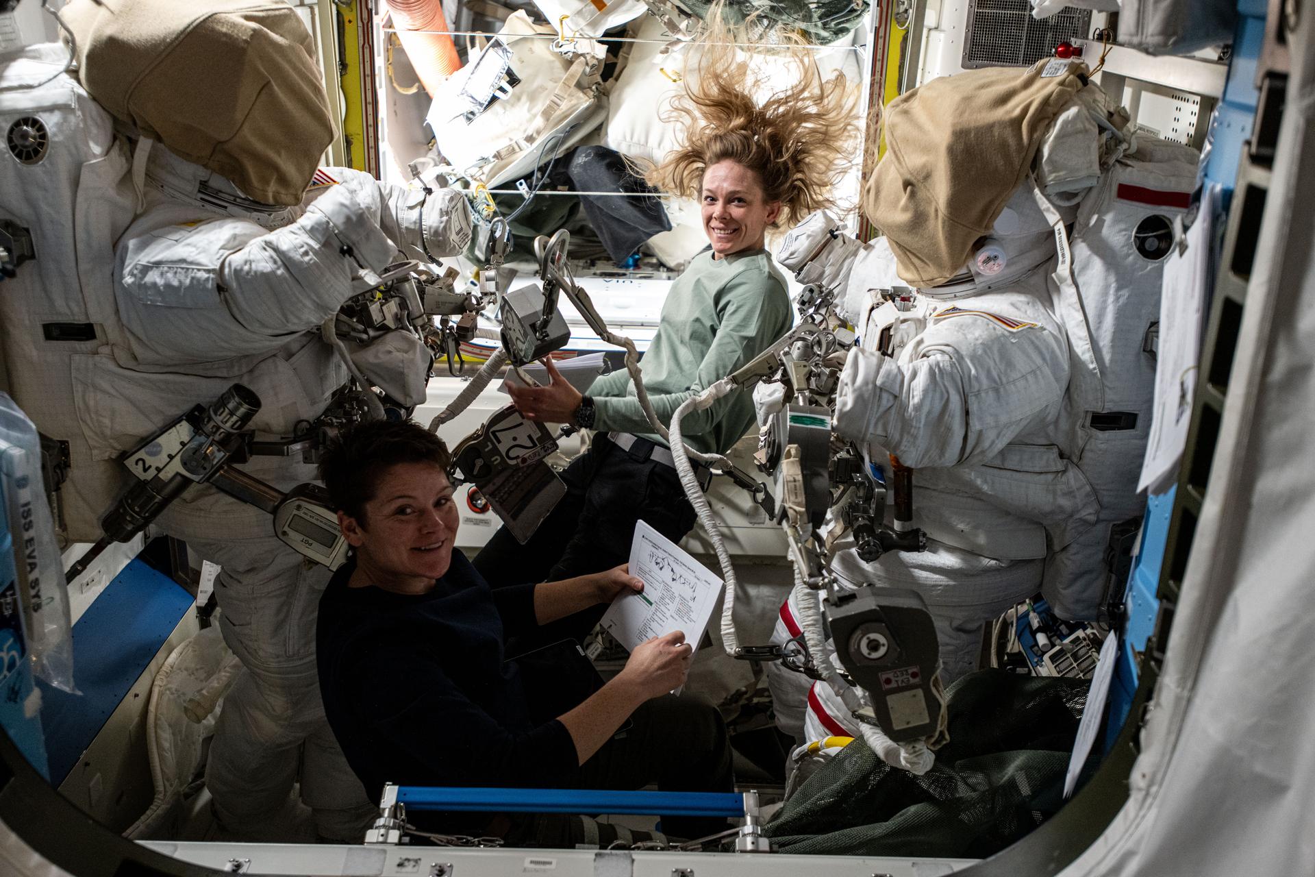 NASA astronauts Anne McClain (bottom) and Nichole Ayers (top), both Expedition 73 Flight Engineers, checkout spacesuit hardware in the Quest airlock and review procedures for a May 1 spacewalk. The spacewalkers will install a modification kit on the International Space Station’s port side truss structure preparing it for a new rollout solar array and relocate an antenna that communicates with commercial spacecraft.