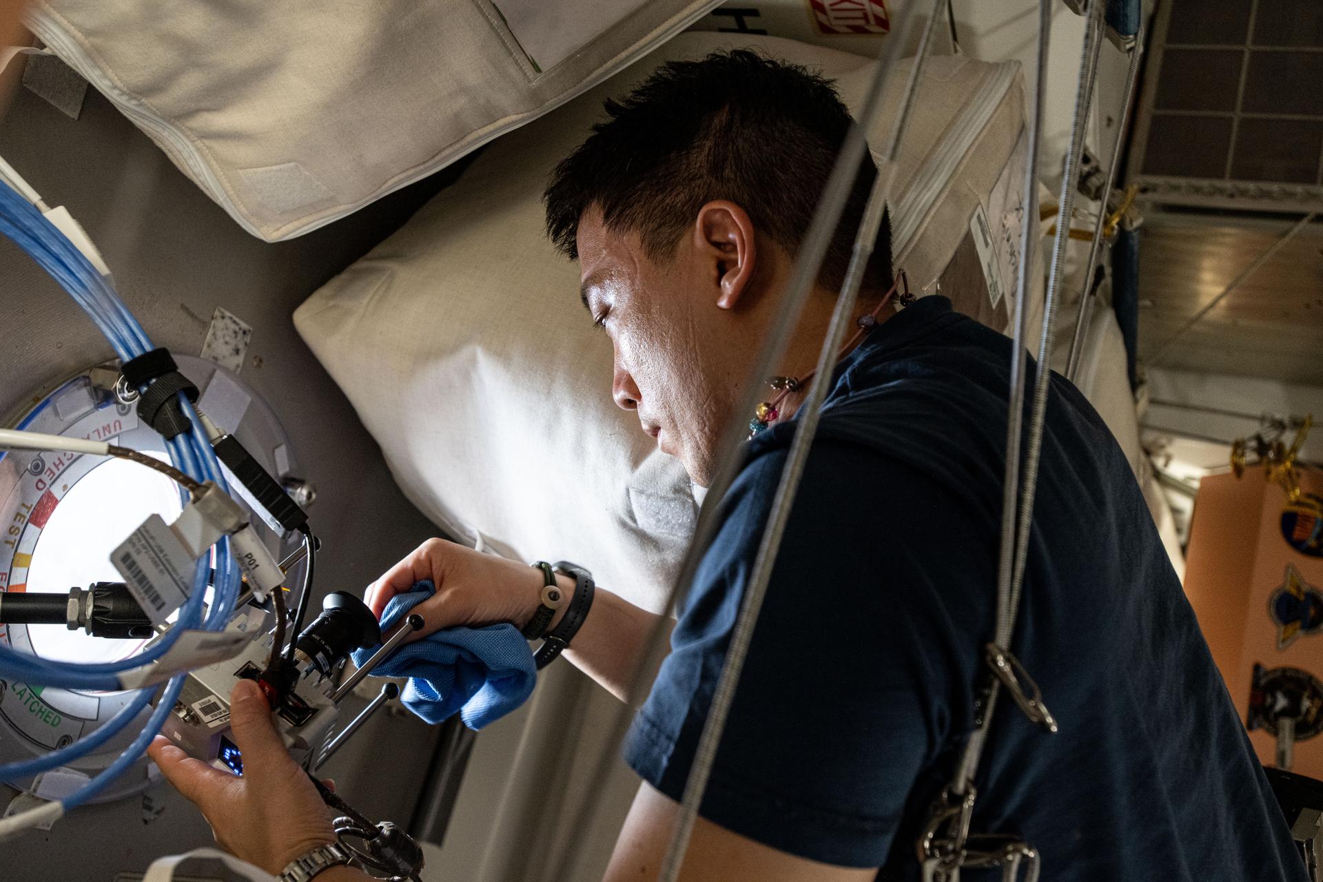 NASA astronaut and Expedition 73 Flight Engineer Jonny Kim works on orbital plumbing duties aboard the International Space Station's Tranquility module.