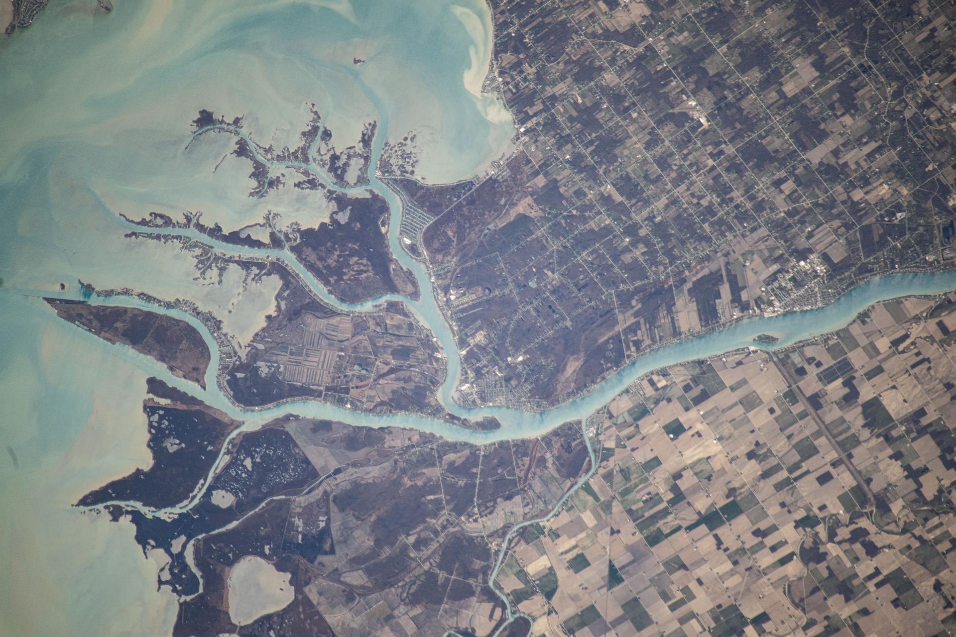 The St. Clair River flows into the freshwater Lake St. Clair and separates the American state of Michigan (top) from the Canadian province of Ontario (bottom) in this photograph from the International Space Station as it orbited 260 miles above.