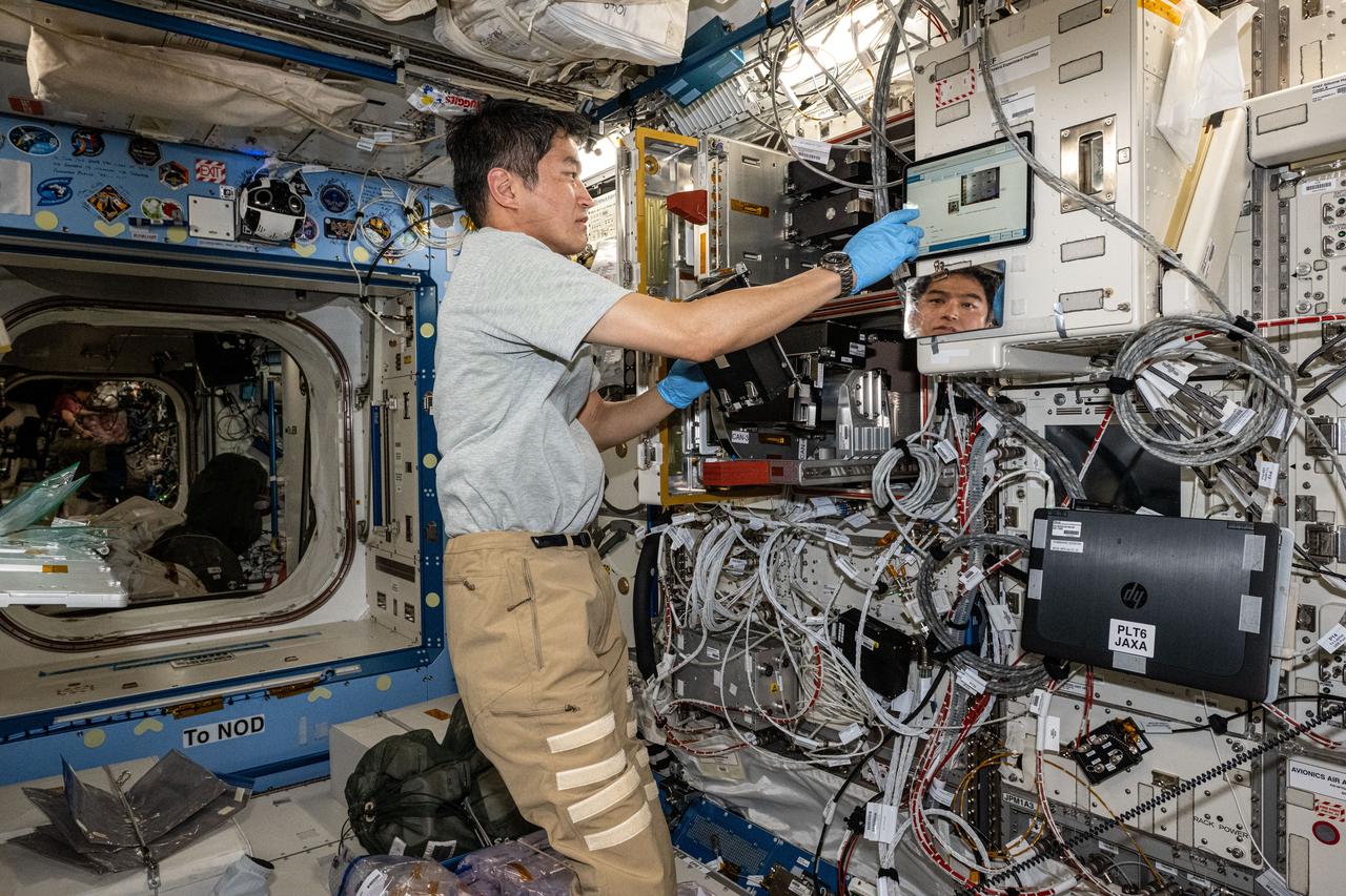 iss073e0000725 (April 23, 2025) --- JAXA (Japan Aerospace Exploration Agency) astronaut and Expedition 73 Commander Takuya Onishi, whose image is reflected in a station mirror, processes research samples for the Cell Gravisensing investigation observing the mechanism that enables cells to sense the effects of gravity. The biotechnology experiment takes place inside the International Space Station's Kibo laboratory module and may lead to therapies treating space-caused and Earthbound muscle and bone conditions.