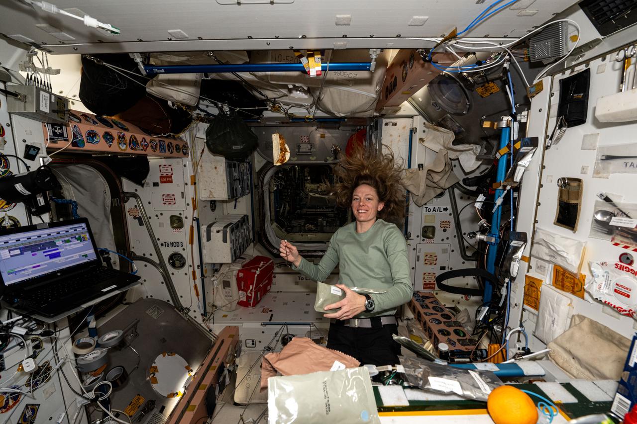 iss073e0000877 (April 21, 2025) --- NASA astronaut and Expedition 73 Flight Engineer Nichole Ayers prepares for a midday meal aboard the Unity module where the International Space Station's galley is located.