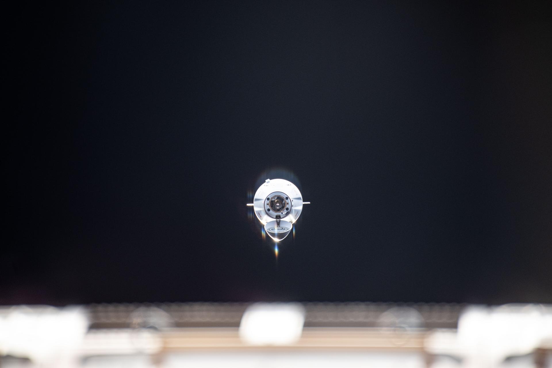 The SpaceX Dragon cargo craft, with its nosecone open, approaches the International Space Station for an automated docking to the Harmony module's space-facing port. Dragon delivered about 6,700 pounds of new science experiments and crew supplies replenishing the Expedition 73 crew.