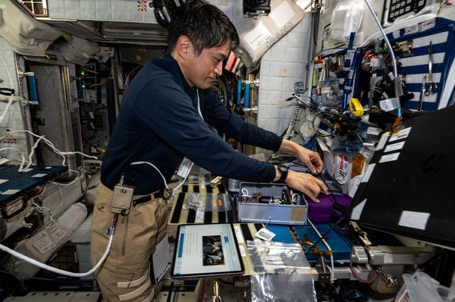 NASA image: Astronaut Takuya Onishi processes cassettes containing biological fluid samples