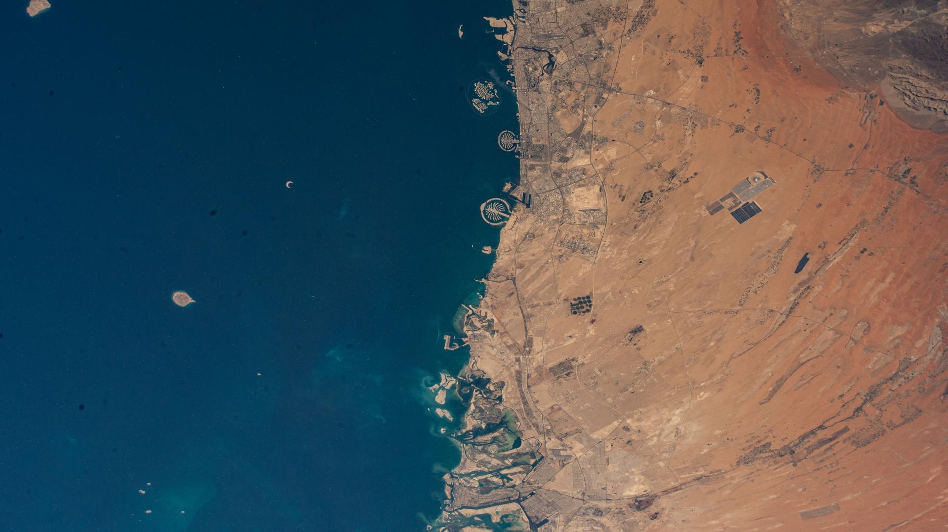 (From top to bottom) The United Arab Emirates' two most populous cities of Dubai and Abu Dhabi with a combined population of nearly 5.8 million, along with the artificial Palm Islands and the World Islands, on the coast of the Persian Gulf are pictured from the International Space Station as it orbited 260 miles above.