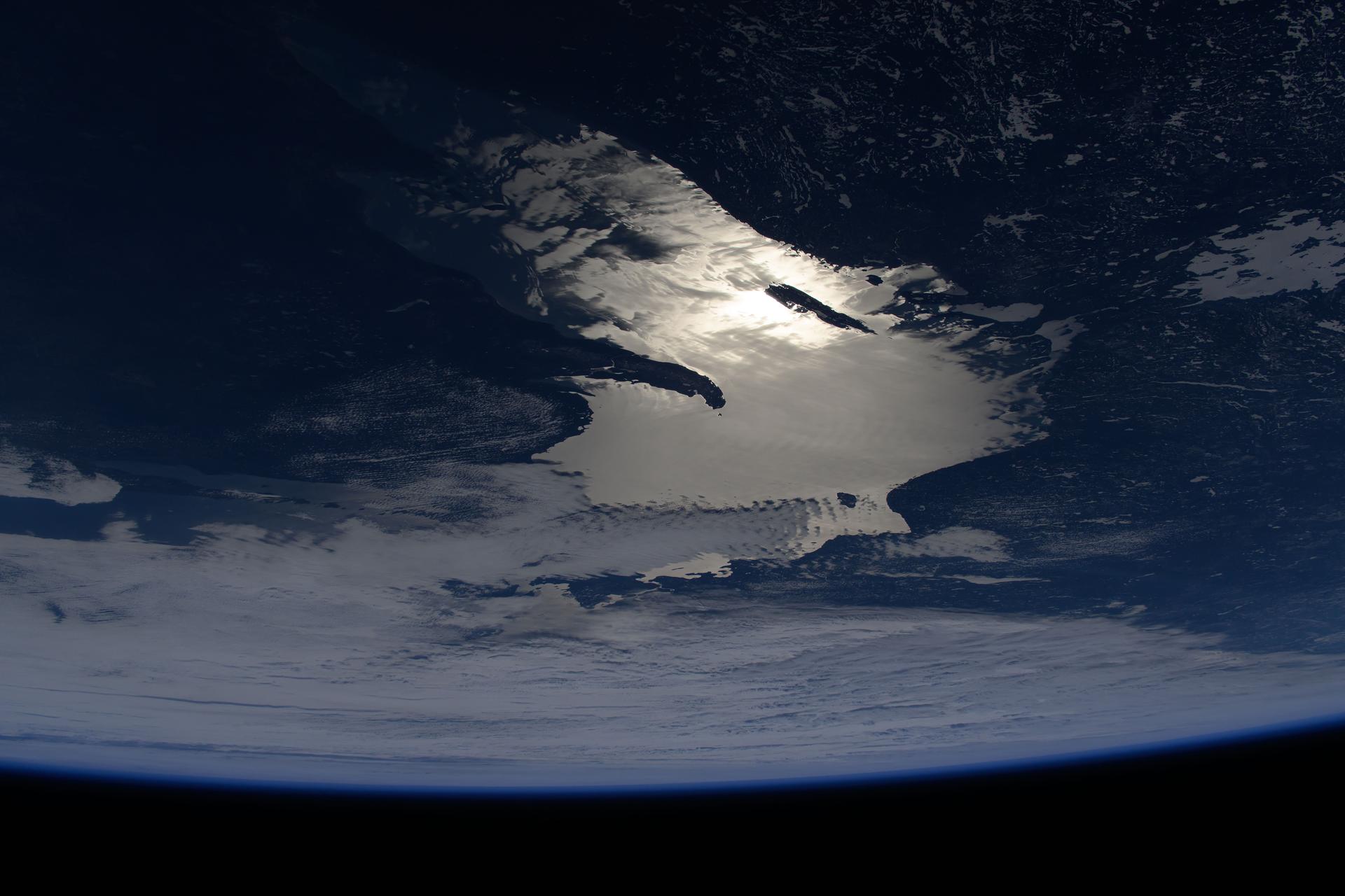 This oblique of view of the sun's glint beaming off Lake Superior was taken at about 8:34 a.m. local time from the International Space Station as it orbited 263 miles above the state of Minnesota, Land of 10,000 Lakes.