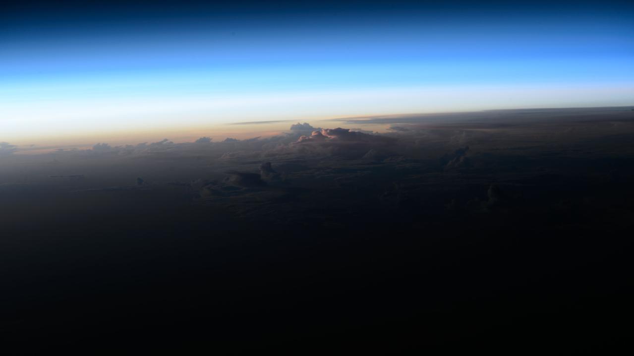 iss073e0028091 (May 11, 2025) --- An orbital sunrise breaks above the clouds in this photograph from the International Space Station as it soared 259 miles over the Atlantic Ocean due west of the African island nation of Cabo Verde.