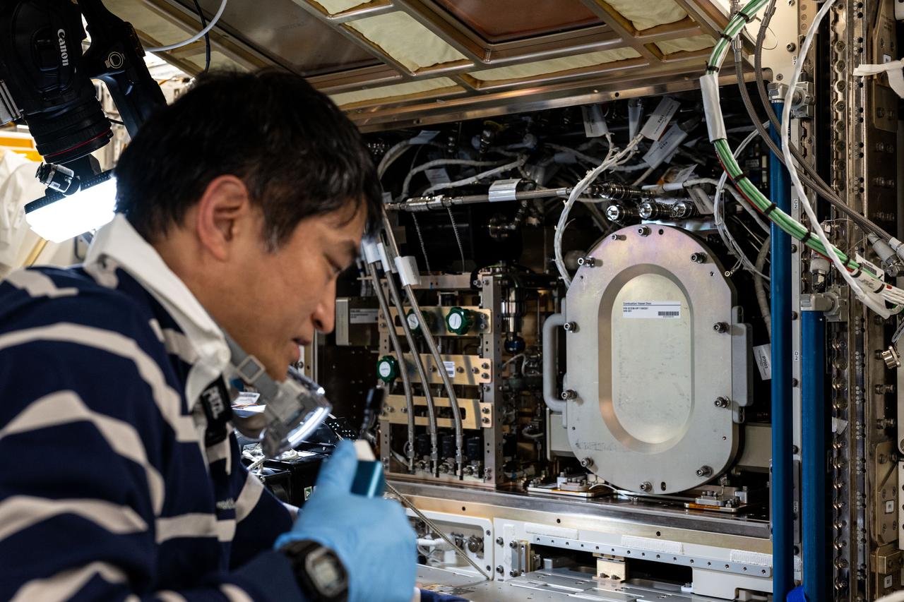 iss073e0030301 (May 13, 2025) --- JAXA (Japan Aerospace Exploration Agency) astronaut and Expedition 73 Commander Takuya Onishi swaps research hardware inside the Kibo laboratory module's solid combustion experiment module. Combustion research aboard the International Space Station helps researchers understand how fuels burn in space, design safer spacecraft, develop new materials, and more aboard the orbital outpost.