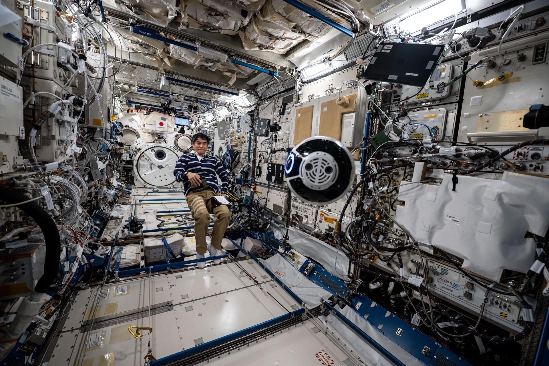 JAXA (Japan Aerospace Exploration Agency) astronaut and Expedition 73 Commander Takuya Onishi monitors the Japanese Experiment Module Internal Ball Camera 2 aboard the International Space Station's Kibo laboratory module. The spherical, free-flying robotic camera tests the automation of capturing video and imagery enabling more crew time for important duties such as microgravity research.