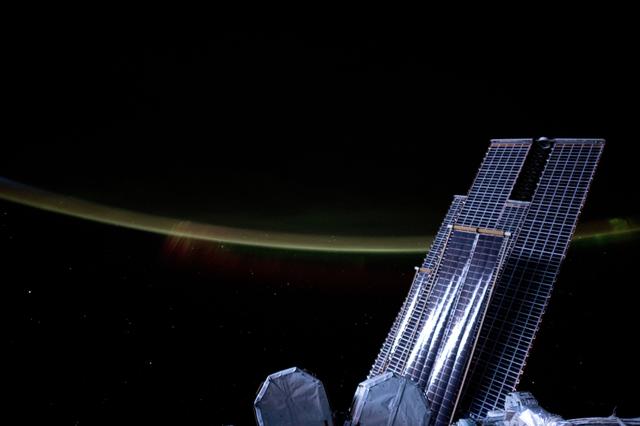 NASA image: Moonlight casts a silvery light on a set of the space station's main solar arrays and rollout solar arrays