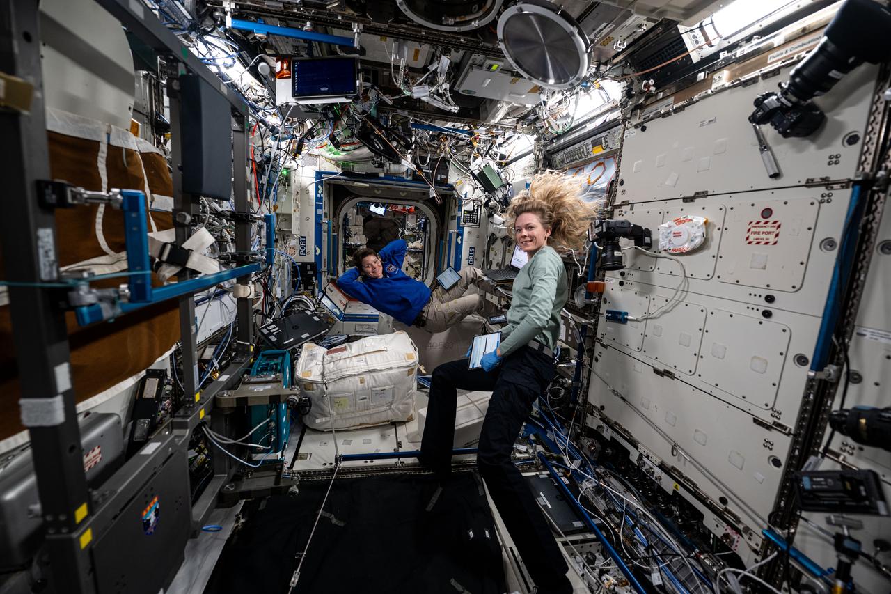 iss073e0071480 (May 15, 2025) --- (From left) Expedition 73 Flight Engineers Anne McClain and Nichole Ayers, both NASA astronauts, take a break and pose for a portrait aboard the International Space Station's Destiny laboratory module.