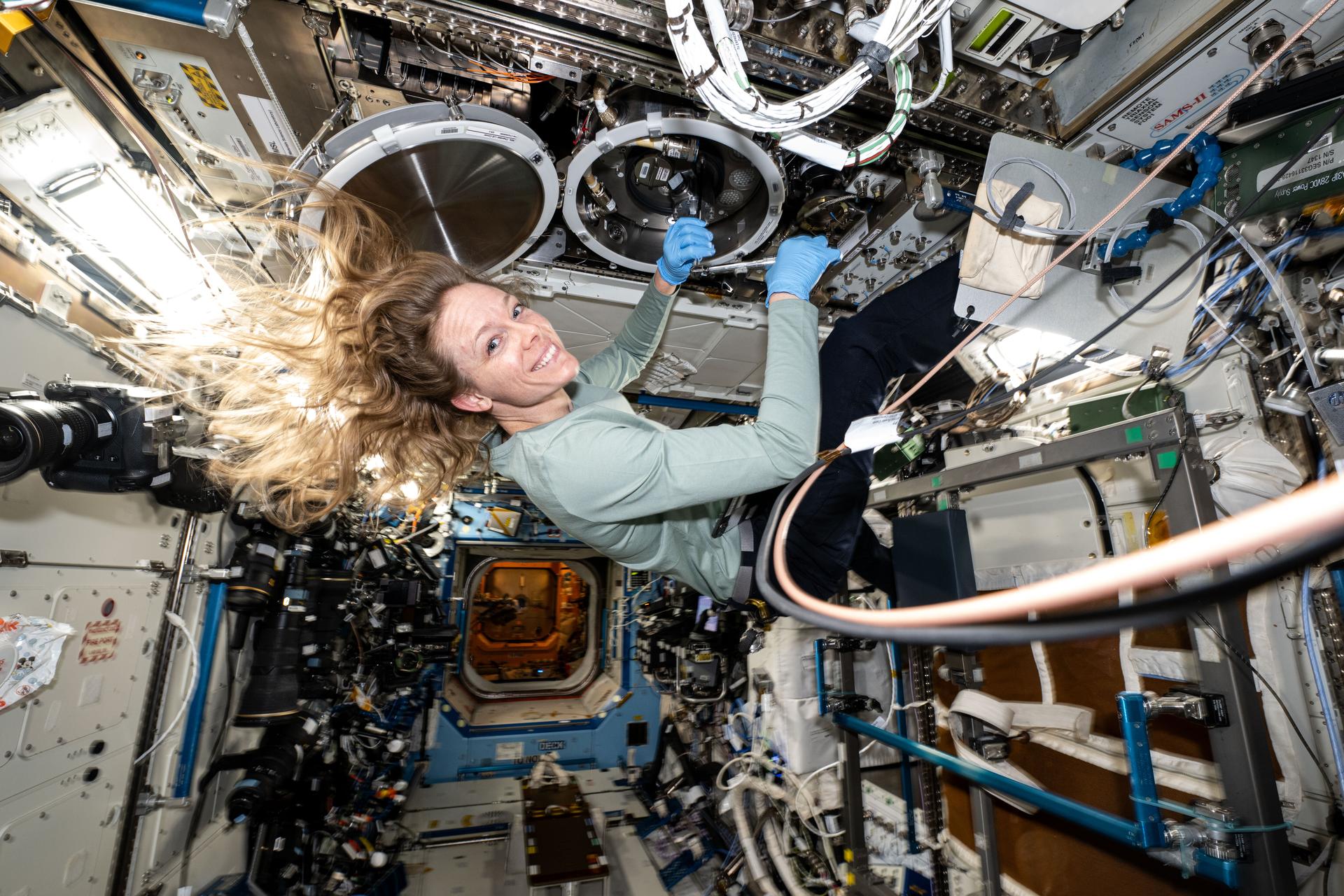 NASA astronaut and Expedition 73 Flight Engineer Nichole Ayers swaps sample cartridges inside the Material Science Laboratory (MSL) that supports high temperature space physics research using furnaces aboard the International Space Station's Destiny laboratory module. The properties of many types of materials such as metals, alloys, polymers, semiconductors, ceramics, crystals, and glasses, can be studied in the MSL to discover new applications for existing materials and new or improved materials.