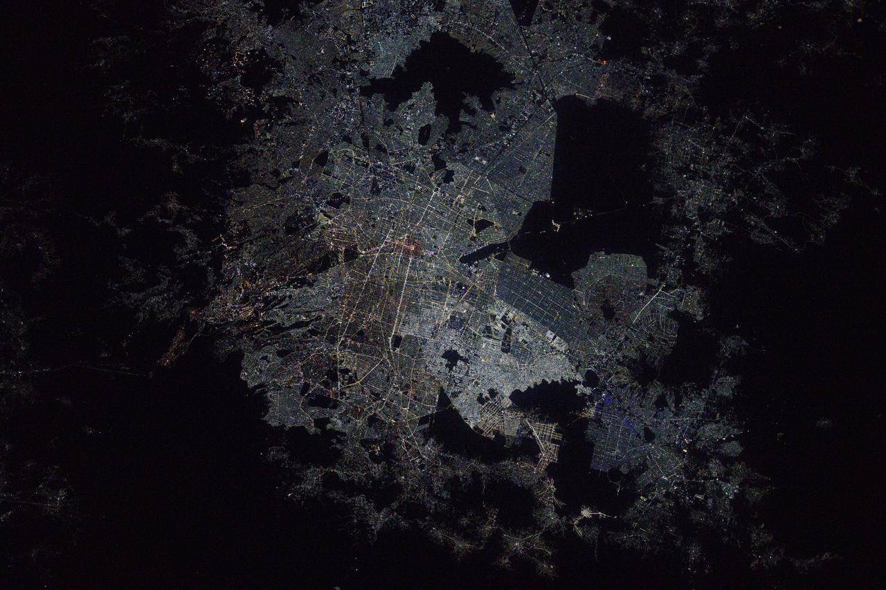 iss073e0075943 (May 16, 2025) --- Mexico City, the capital and most-populous city of the Latin American nation, surrounded by the dark voids of Lago de Texcoco nature preserve, the Lago Tláhuac-Xico nature preserve, and the Cumbres del Ajusco National Park is pictured at approximately 3 a.m. local time from the International Space Station as it orbited 259 miles above.