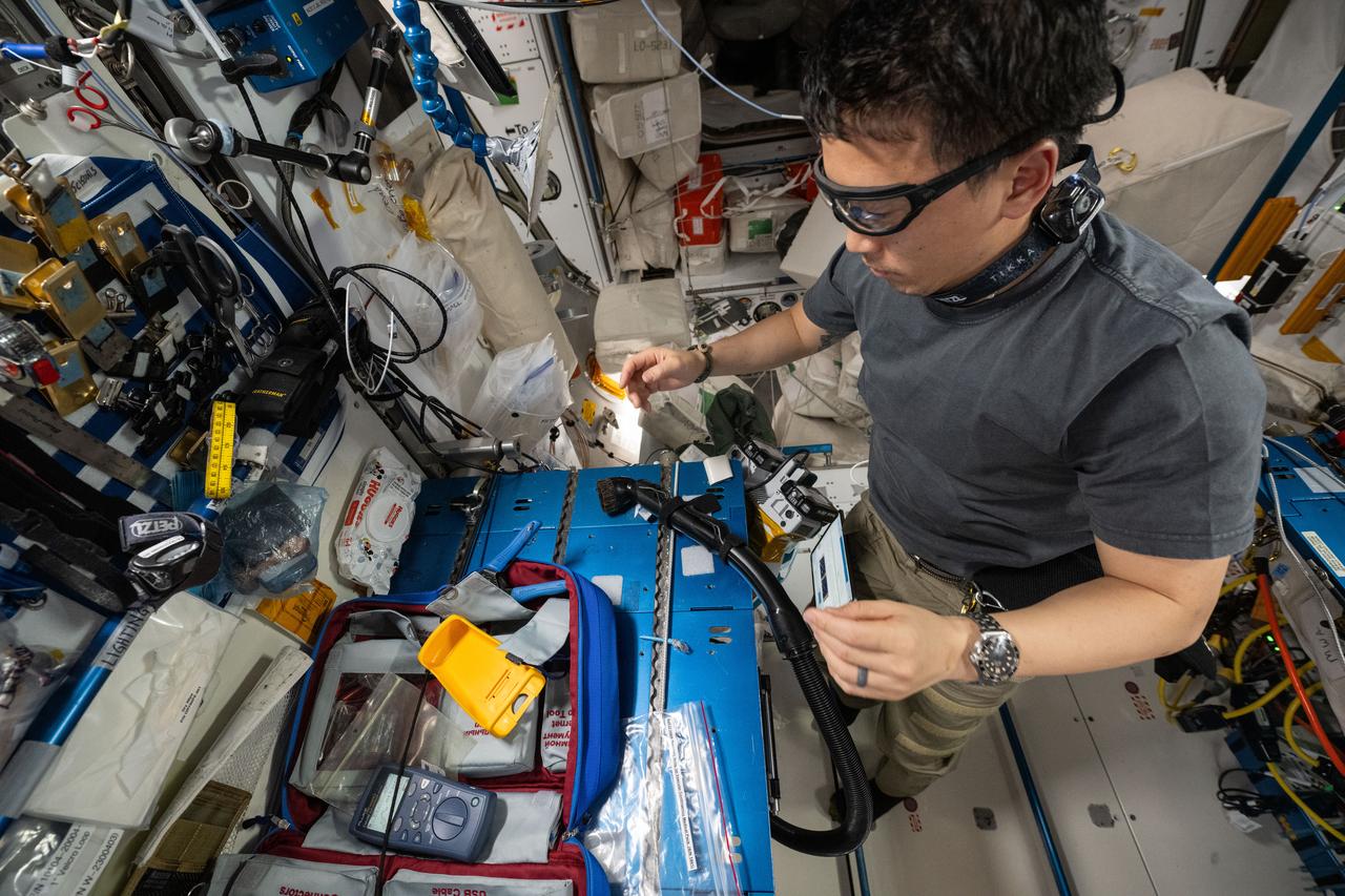 iss073e0077576 (May 20, 2025) --- NASA astronaut and Expedition 73 Flight Engineer Jonny Kim repairs ethernet cables aboard the International Space Station's Harmony module.