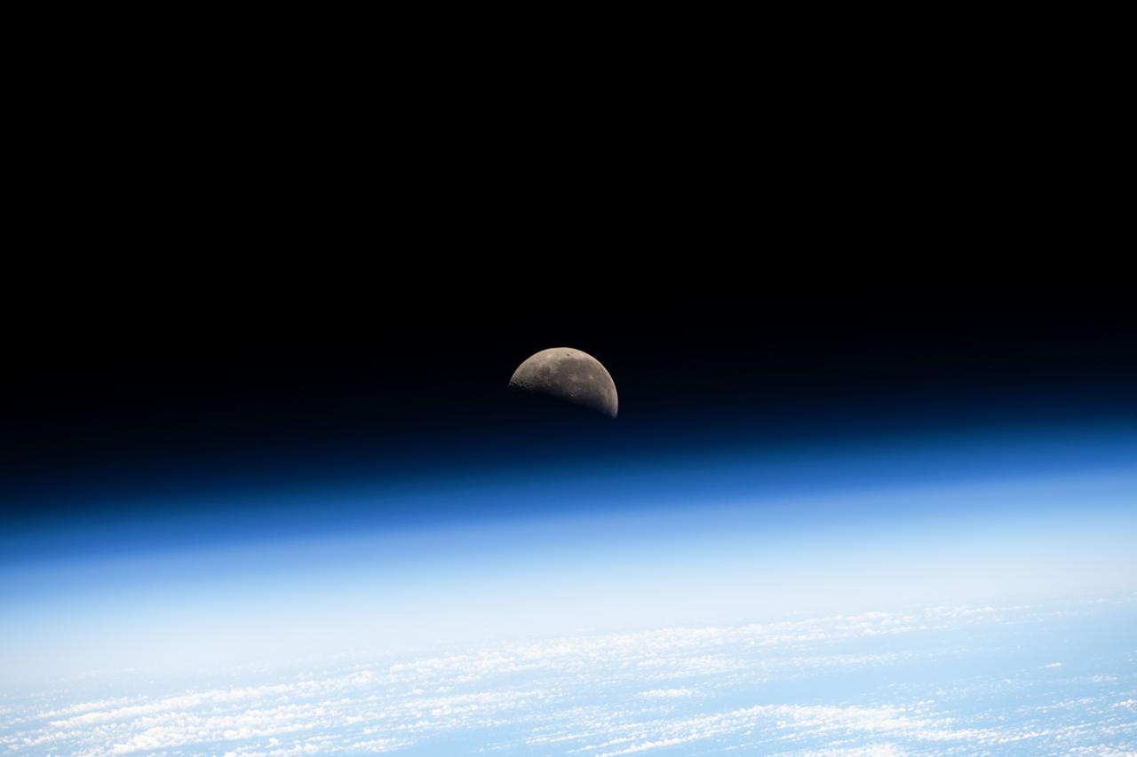 iss073e0077872 (May 20, 2025) --- The Last Quarter Moon is pictured above Earth's atmosphere from the International Space Station as it soared 260 miles over the Pacific Ocean southwest of Panama on the Latin American continent.