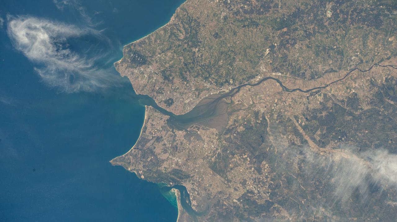 iss073e0078399 (May 22, 2025) --- Lisbon, the capital and largest city of Portugal, and its suburbs on the River Tagus that leads into the Atlantic Ocean are pictured from the International Space Station as it orbited 261 miles above the nation's coast on the Iberian Peninsula.