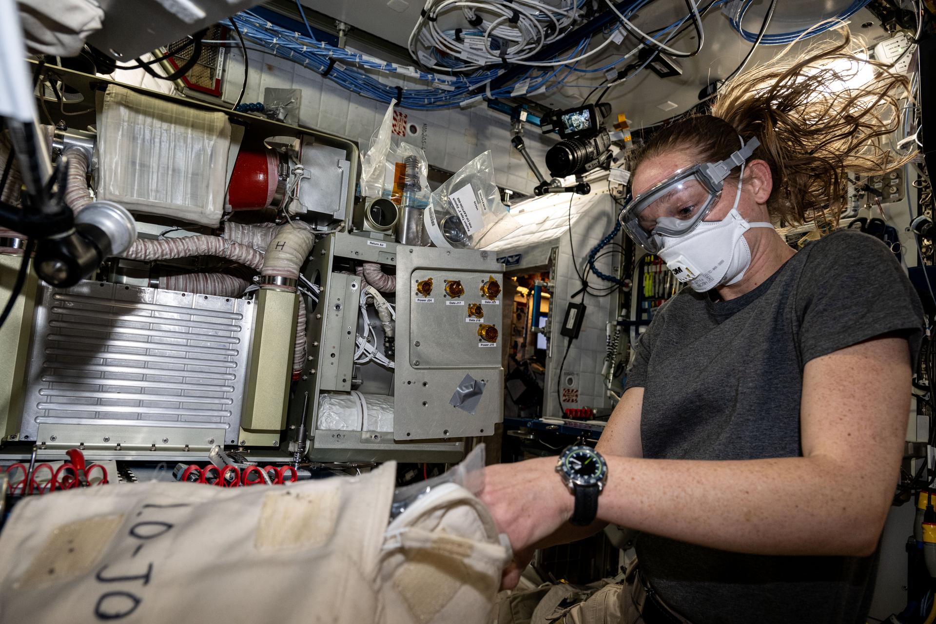 NASA astronaut and Expedition 73 Flight Engineer Nichole Ayers replaces components on an experimental carbon dioxide removal device. Also called the Thermal Amine Scrubber, the advanced life support mechanism is testing a new method that removes carbon dioxide from the station’s atmosphere and recovers water for oxygen generation.