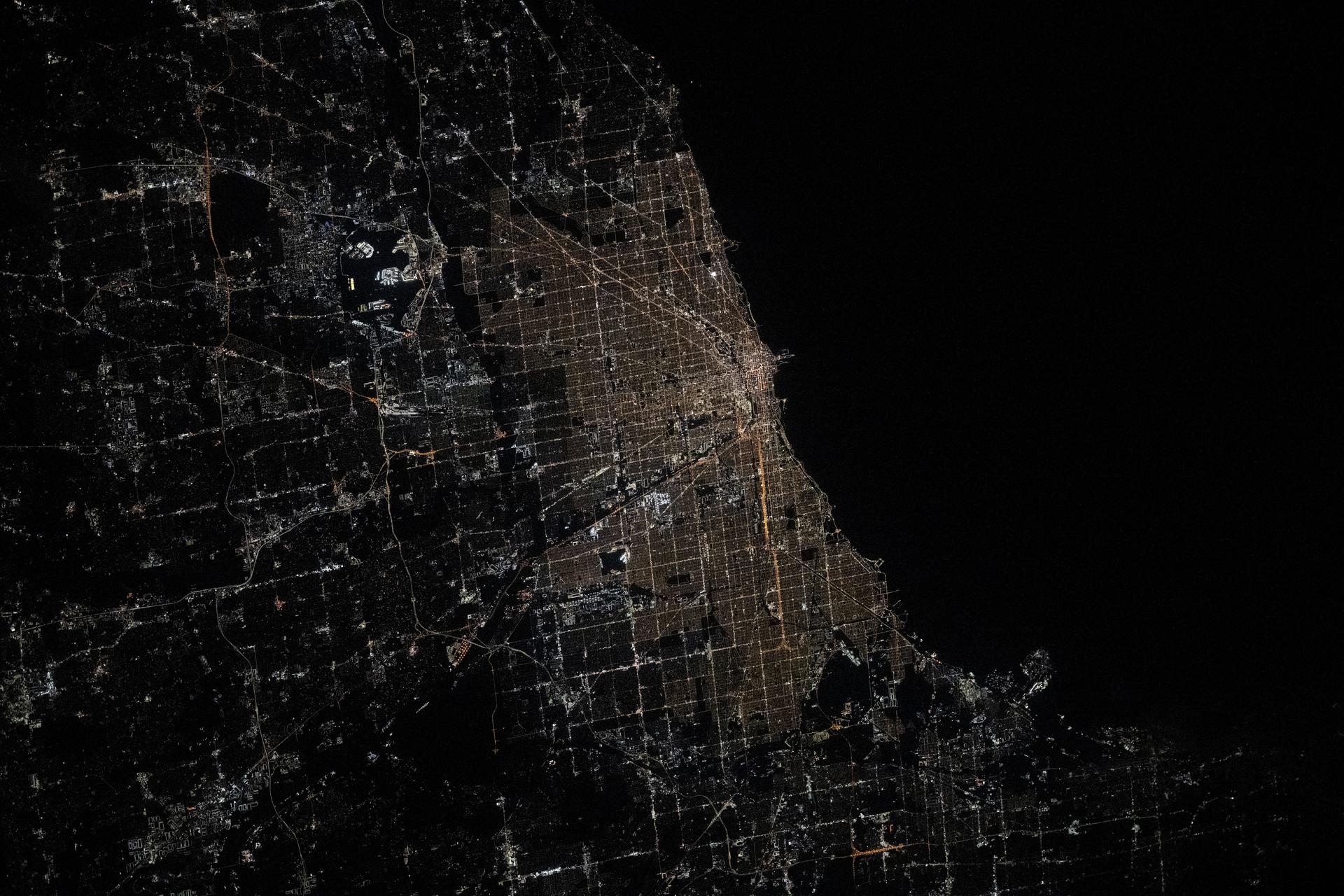Chicago, Illinois, with a metropolitan population of 9.6 million near the southern tip of Lake Michigan, is pictured at approximately 1:32 a.m. local time from the International Space Station as it orbited 261 miles above.