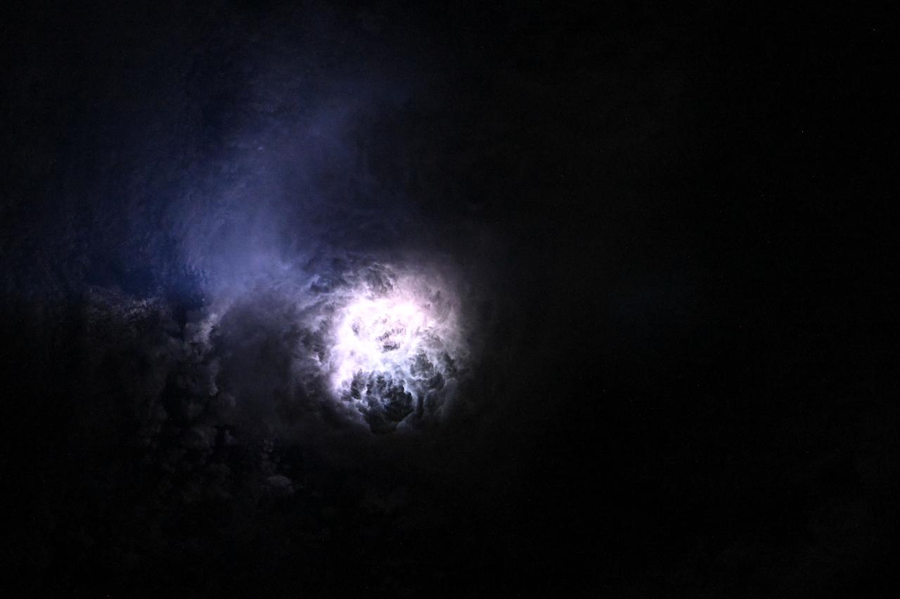 iss073e0080625 (May 15, 2025) --- This nebula-like formation is actually lightning illuminating the clouds during a storm off the coast of North Carolina in this photograph from the International Space Station as it orbited 260 miles above the Atlantic Ocean.