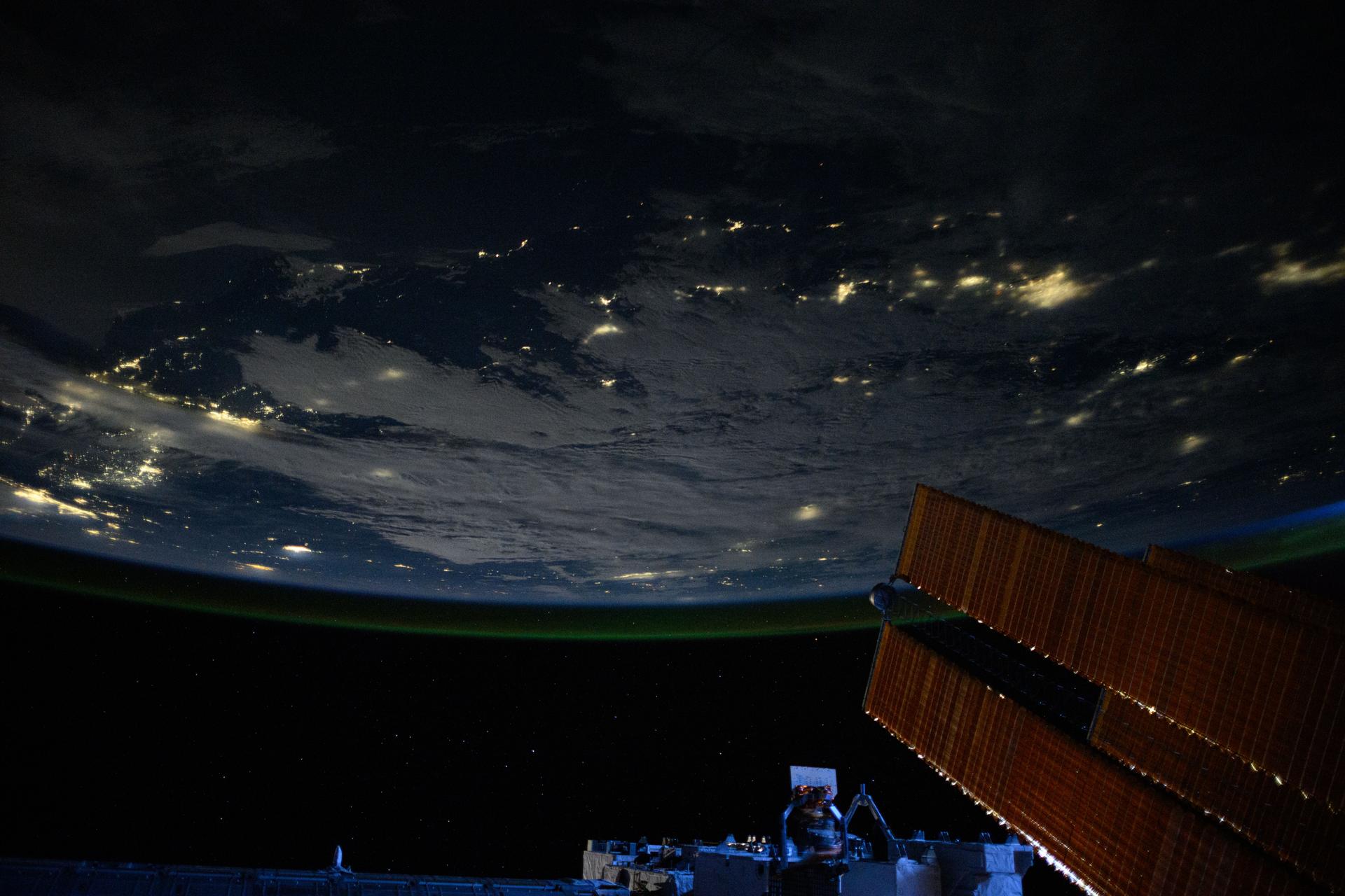 City lights dot the Pacific Northwest region of North America at approximately 2:50 a.m. local time in this photograph from the International Space Station as it orbited 261 miles above the Pacific Ocean. In the lower right foreground, is a set of the orbital outpost's main solar arrays.