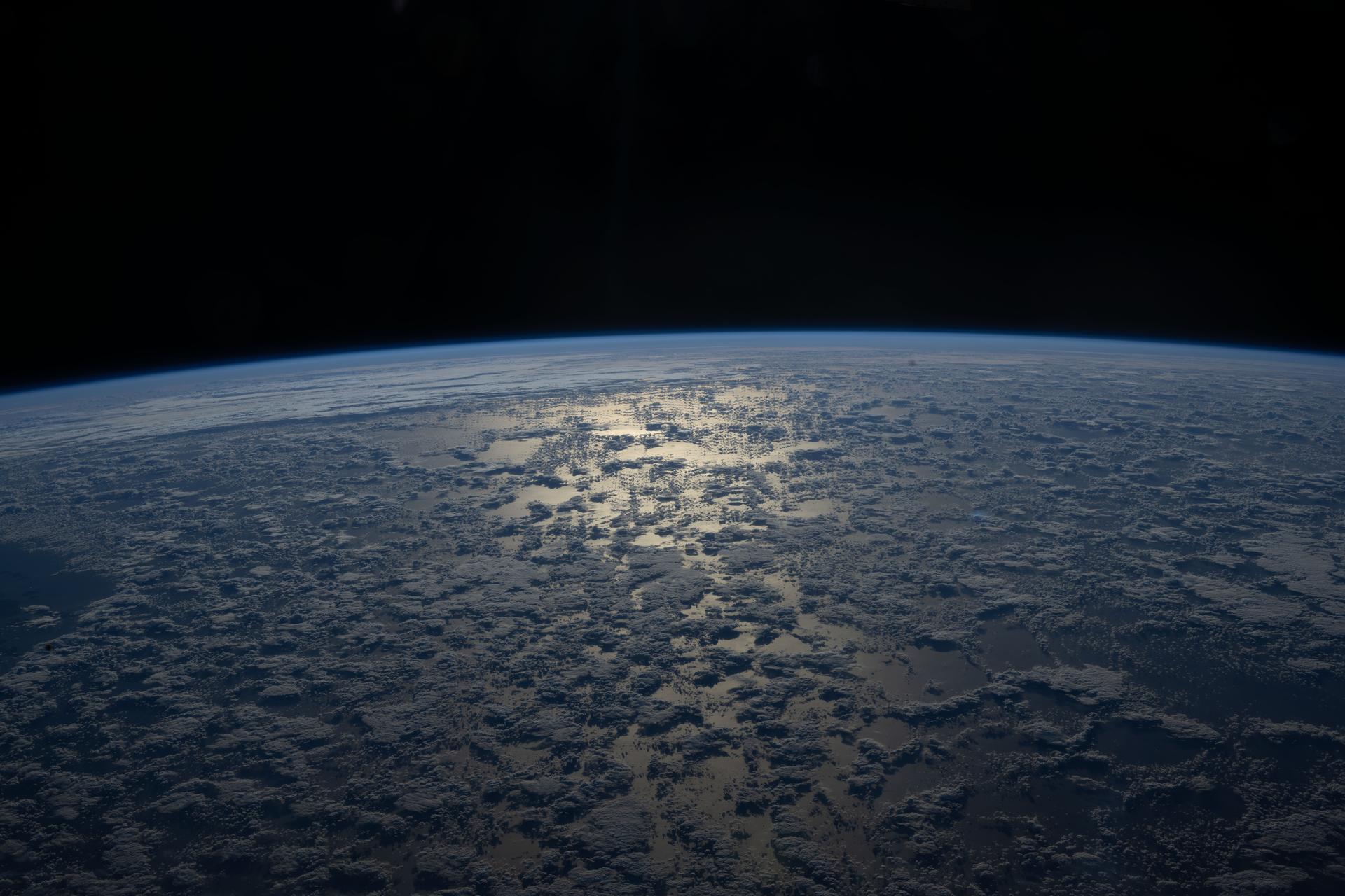 The Sun's glint beams off a partly cloudy Indian Ocean in this photograph from the International Space Station as it orbited 271 miles above and south of Australia's island state of Tasmania.