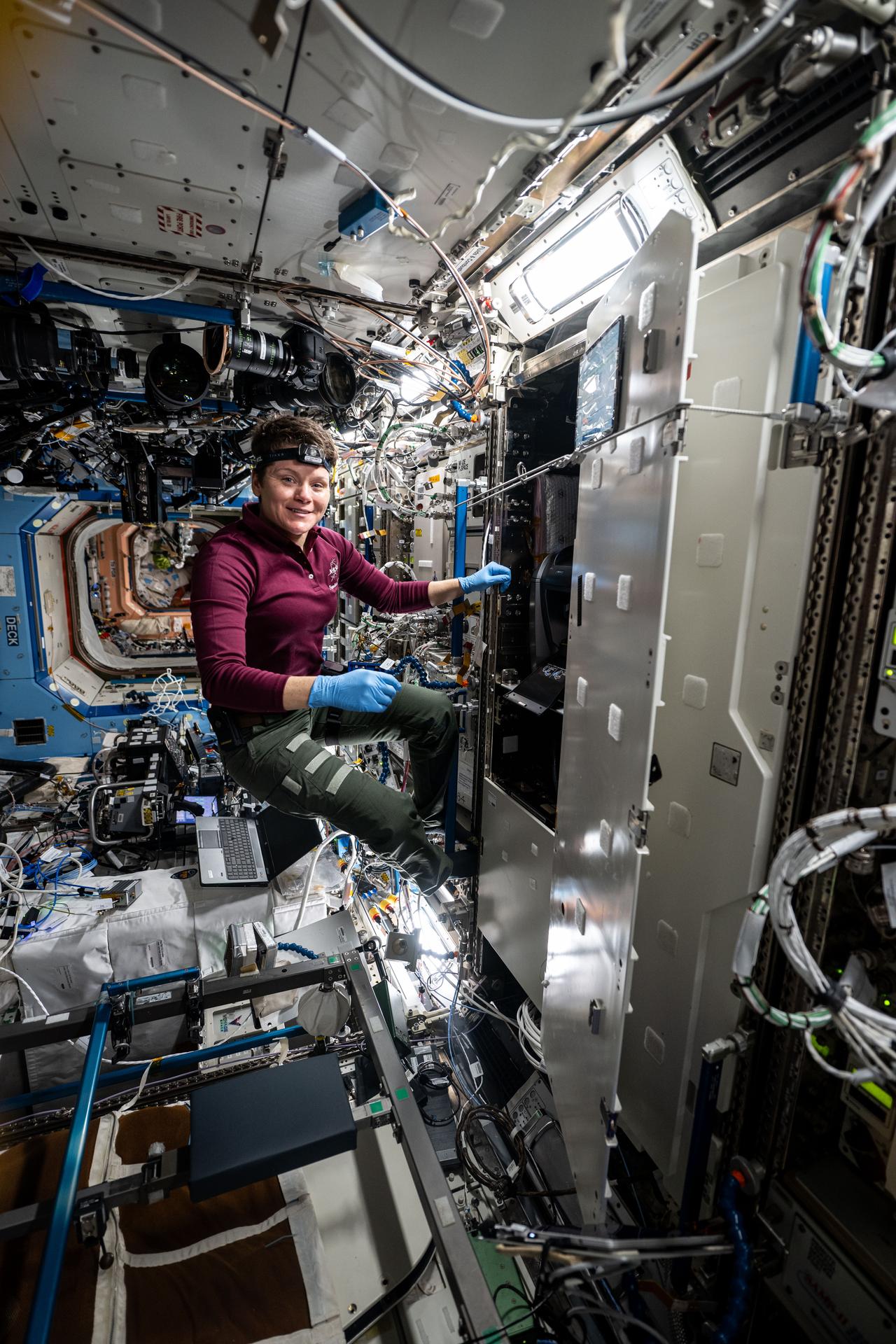 NASA astronaut and Expedition 73 Flight Engineer Anne McClain works inside the Destiny laboratory module's Materials Science Research Rack and swaps filters inside the Kermit microscope. Kermit is an all-in-one fluorescence microscope system used to conduct biological, physical, and materials science research.