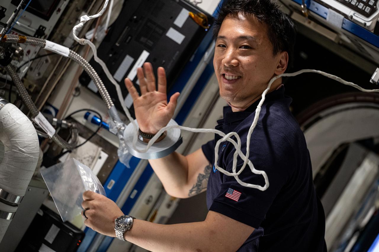 iss073e0118580 (May 27, 2025) --- NASA astronaut and Expedition 73 Flight Engineer Jonny Kim services an experimental carbon dioxide removal device aboard the International Space Station. Also called the Thermal Amine Scrubber, the advanced life support mechanism is testing a new method that removes carbon dioxide from the station’s atmosphere and recovers water for oxygen generation.