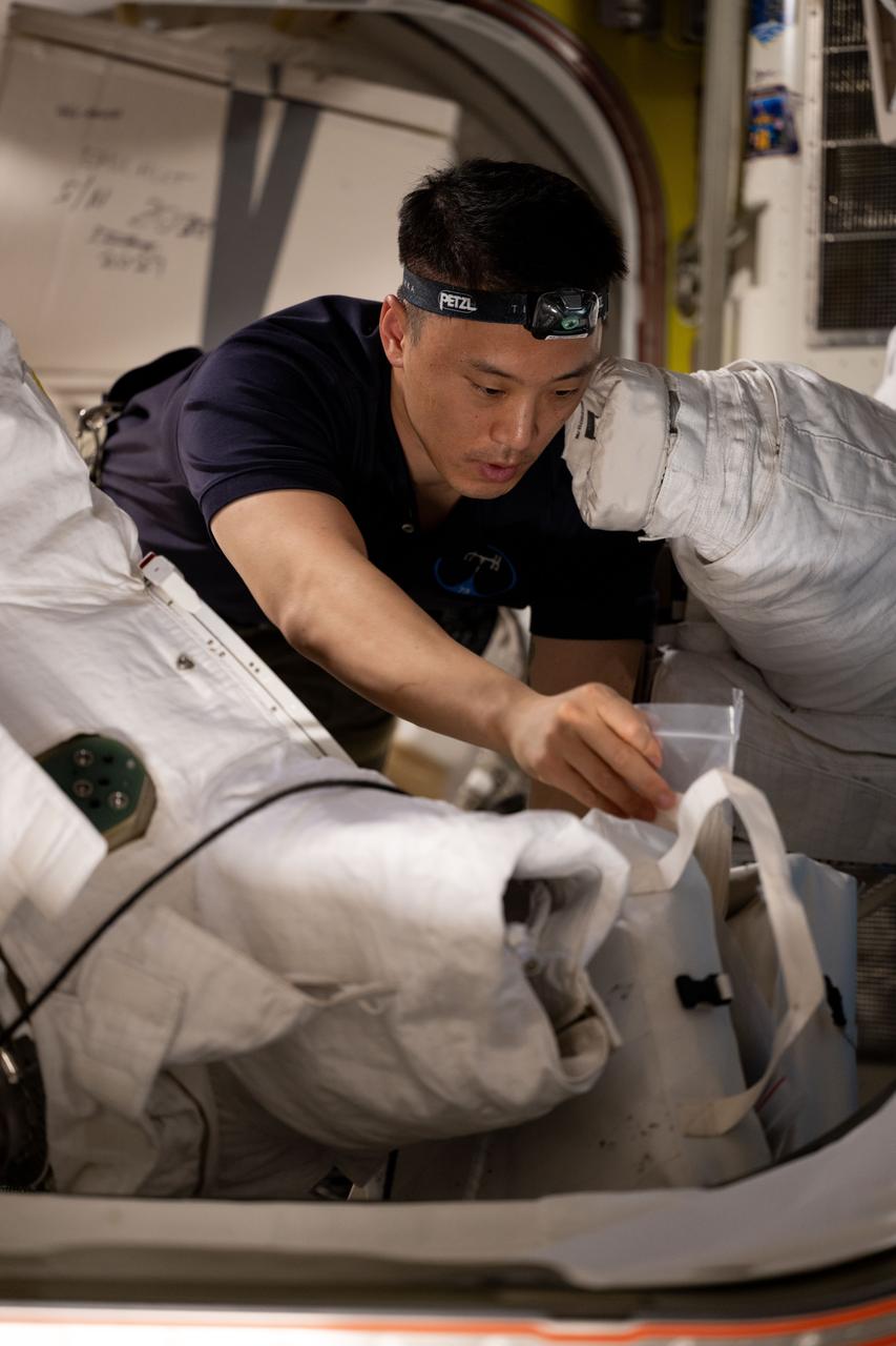 iss073e0118752 (May 29, 2025) --- NASA astronaut and Expedition 73 Flight Engineer Jonny Kim works on spacesuit maintenance operations inside the International Space Station's Quest airlock.