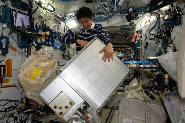 NASA image:  JAXA astronaut Takuya Onishi replaces components on an experimental carbon dioxide removal device