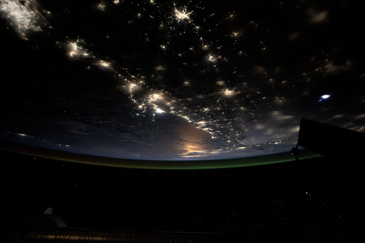 iss073e0123876 (May 19, 2025) --- The Gulf of America coast lit by the city lights from Houston, Texas, (upper left) to the Florida peninsula and an atmospheric glow crowning Earth's atmosphere are pictured from the International Space Station as it orbited 260 miles above the Lone Star State.