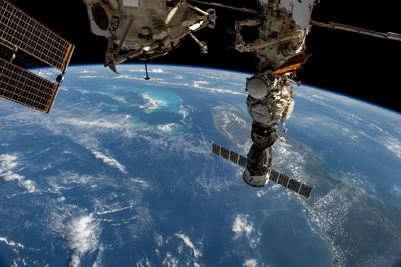 iss073e0134239 (May 20, 2025) --- The Soyuz MS-27 spacecraft that launched three Expedition 72-73 flight engineers to the International Space Station on April 8, 2025, is pictured docked to the Prichal module. 261 miles below the orbital outpost is the state of Florida and the island country of the Bahamas, also known as the Commonwealth of the Bahamas, in the Atlantic Ocean.