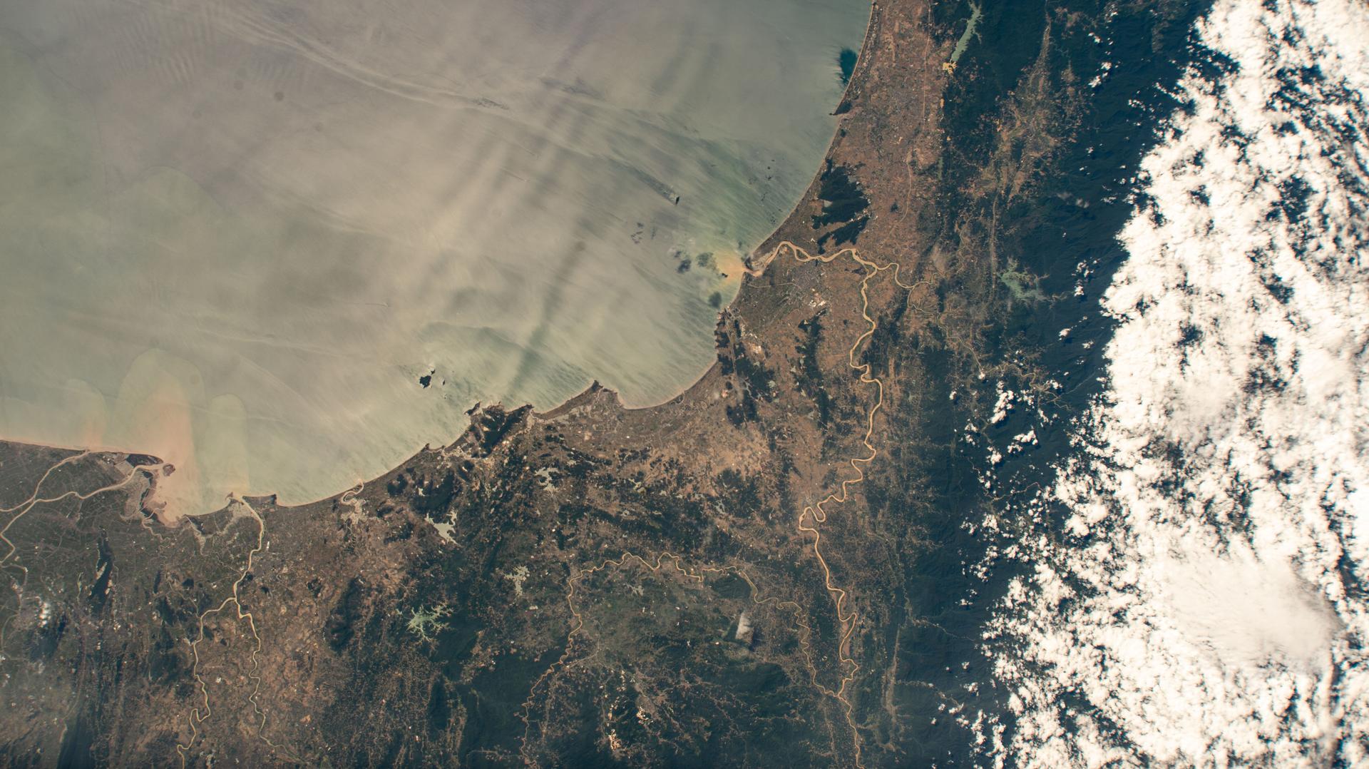 The north central Vietnamese coast on the South China Sea, in between the cities of Thanh Hóa on the Nam River (left) and Vinh on the Cá River (right), is pictured from the International Space Station as it orbited 260 miles above Southeast Asia.