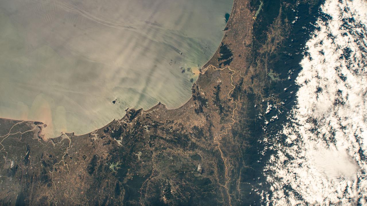 iss073e0134286 (June 2, 2025) --- The north central Vietnamese coast on the South China Sea, in between the cities of Thanh Hóa on the Nam River (left) and Vinh on the Cá River (right), is pictured from the International Space Station as it orbited 260 miles above Southeast Asia.