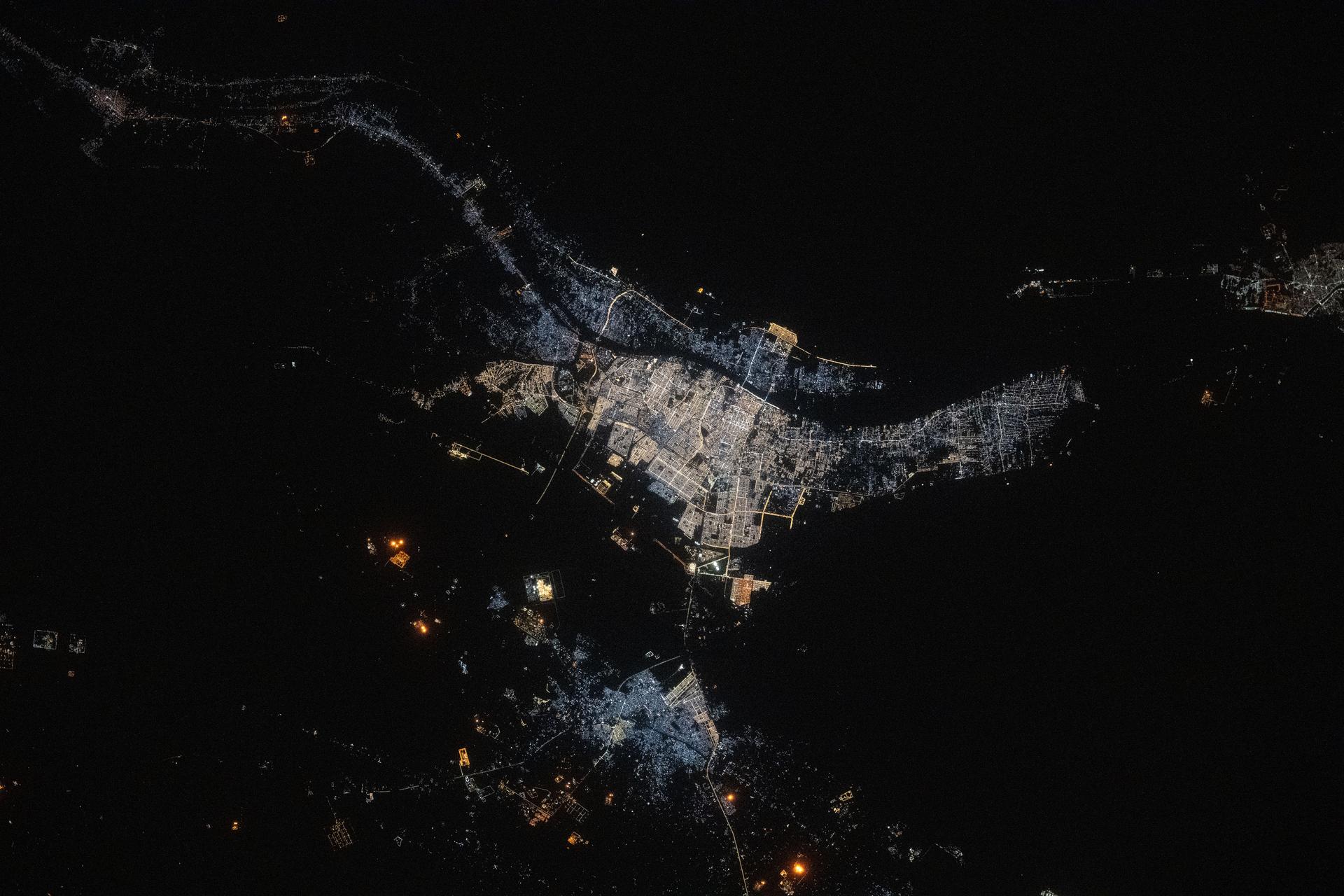 The port city of Basrah, Iraq, with a population of about 1.49 million near the Persian Gulf and split by the Shatt Al Arab river, is pictured at approximately 10:42 p.m. local time from the International Space Station as it orbited 260 miles above the Middle East.