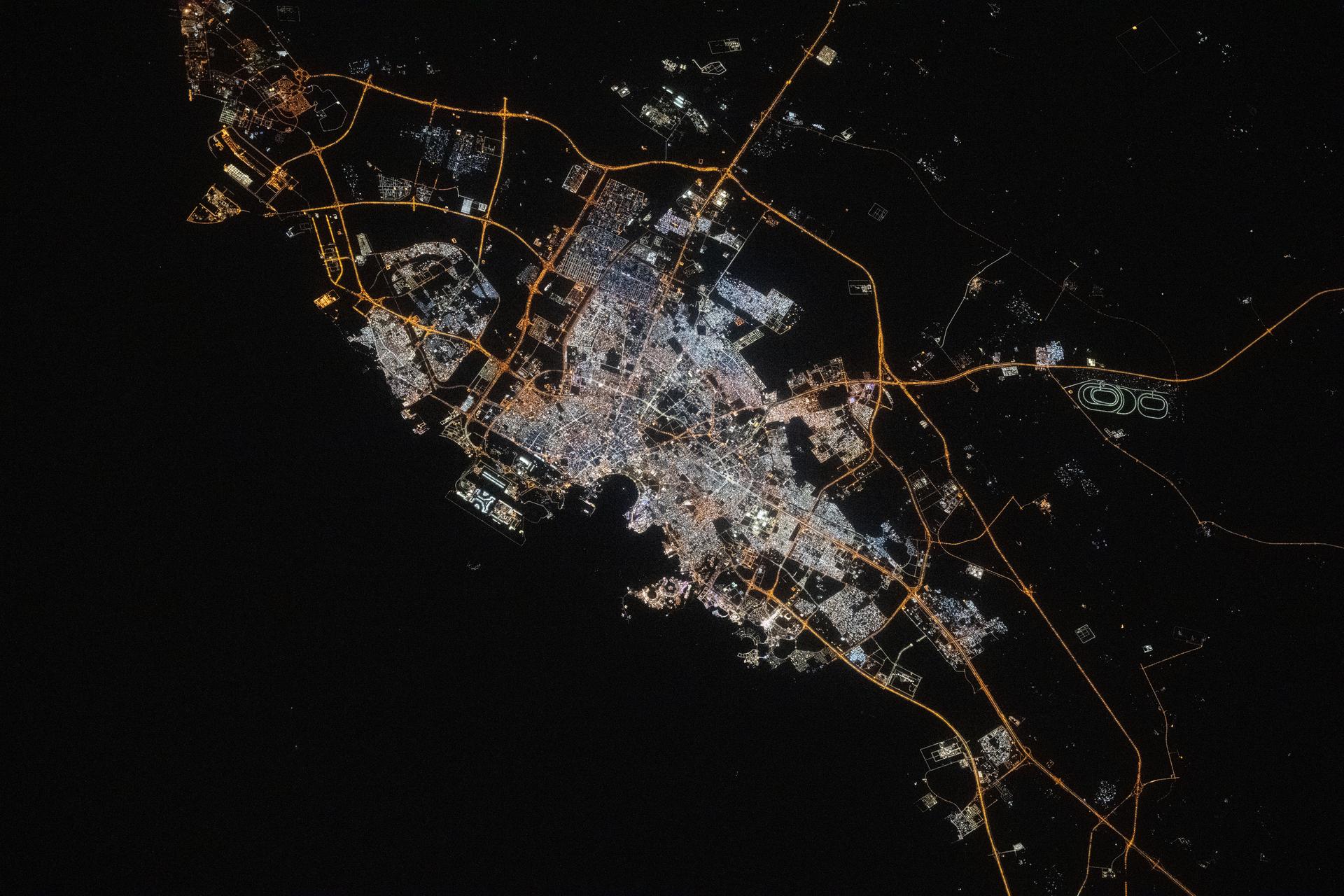 Doha, the capital and largest city of Qatar with a population of about 1.9 million, is pictured at approximatelt 10:44 p.m. local time from the International Space Station as it orbited 259 miles above the Persian Gulf. Landmarks include Hamad International Airport (center left) and the artificial Pearl Island (lower center).