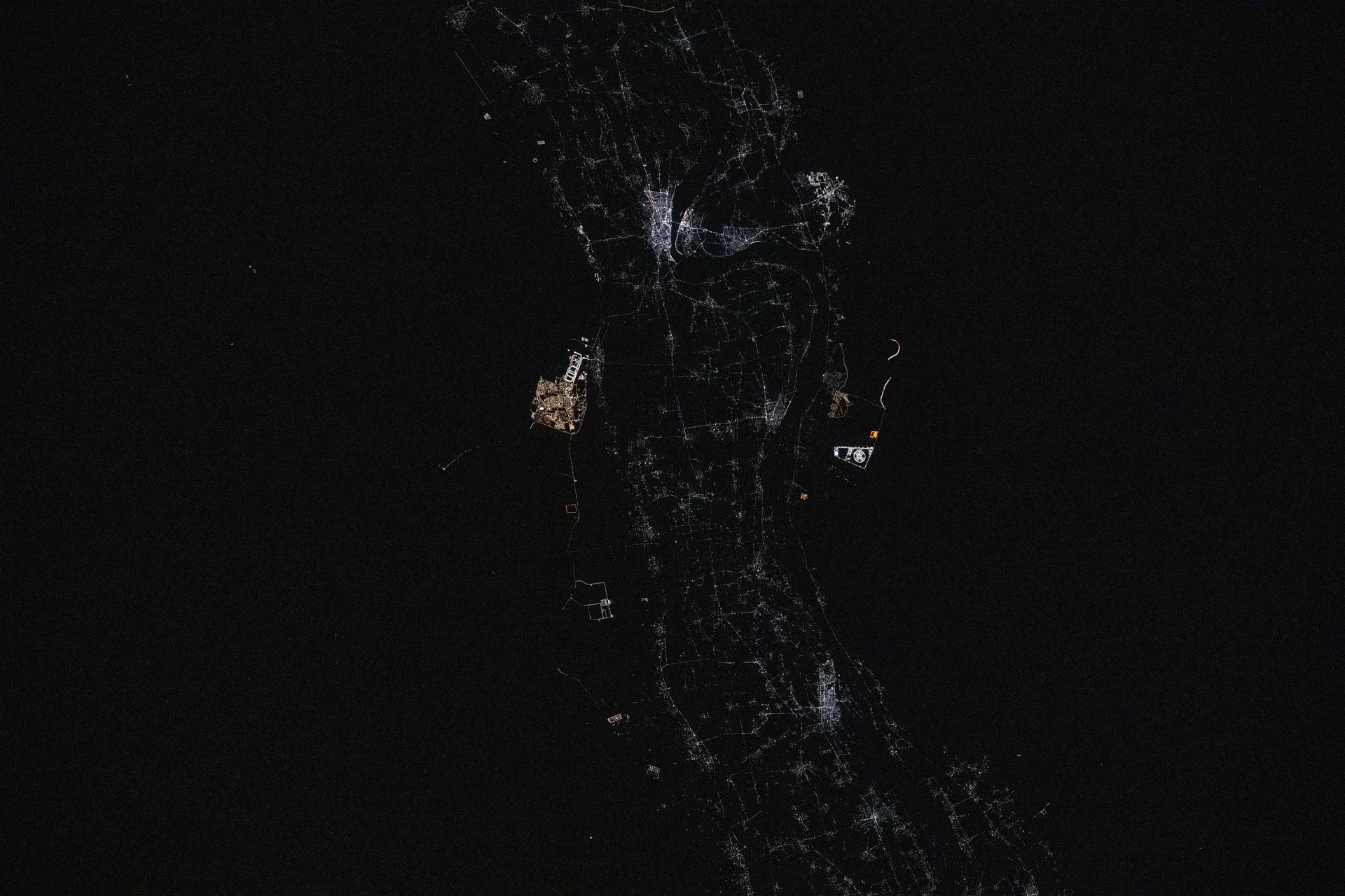 Sohag, Egypt (top center), on the River Nile's fertile plain with a population of about 270,000, is pictured at approximately 12:17 a.m. local time from the International Space Station as it orbited 259 miles above. Just to the south of Sohag, is the city of Sohag Al Gadida City, or New Sohag, established in 2000.