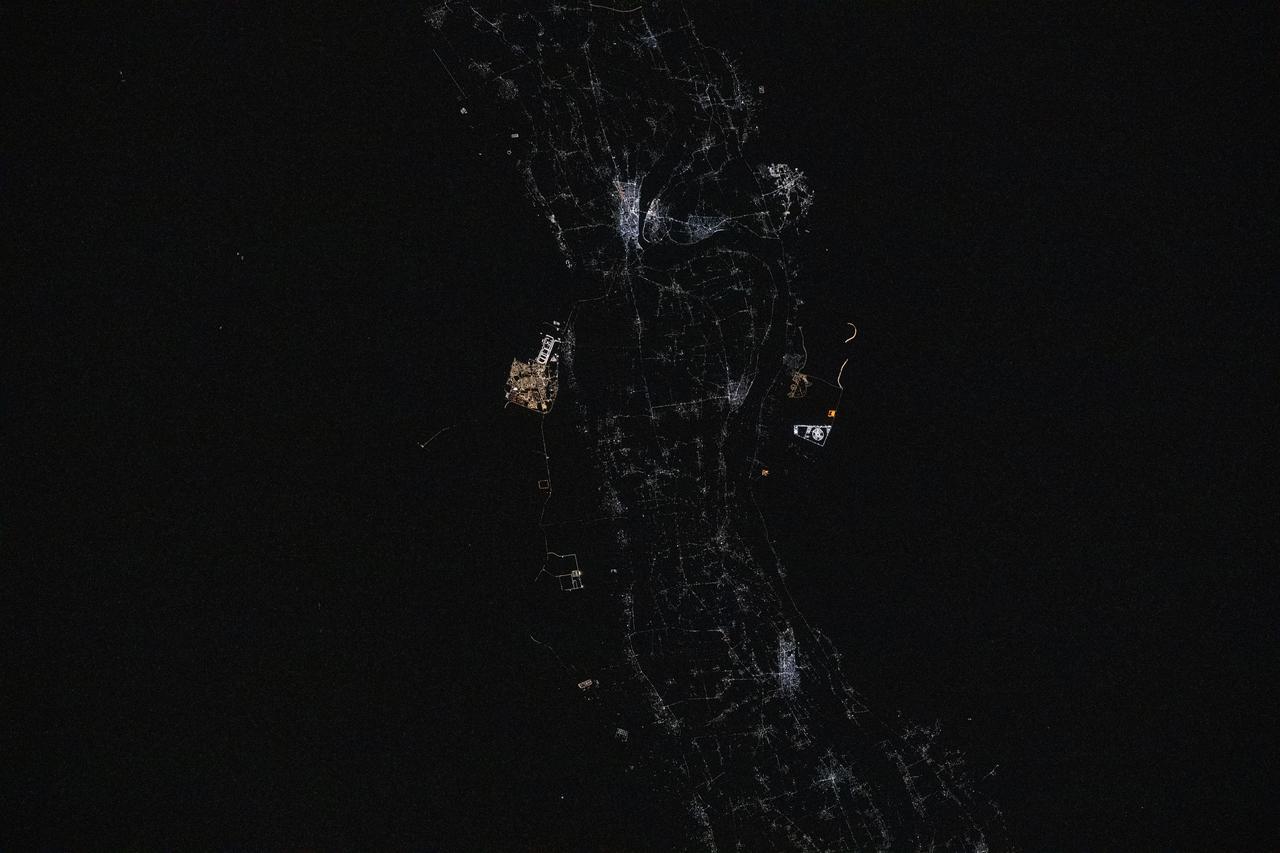 iss073e0134645 (May 22, 2025) --- Sohag, Egypt (top center), on the River Nile's fertile plain with a population of about 270,000, is pictured at approximately 12:17 a.m. local time from the International Space Station as it orbited 259 miles above. Just to the south of Sohag, is the city of Sohag Al Gadida City, or New Sohag, established in 2000.