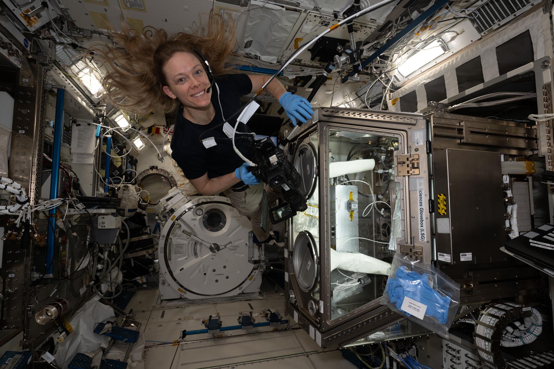 NASA astronaut and Expedition 73 Flight Engineer Nichole Ayers works inside the Kibo laboratory module to test imaging operations of a 3D research microscope, also known as the Extant Life Volumetric Imaging System, or ELVIS. The specialized 3D imaging device, located in Kibo's Life Science Glovebox, could be used to monitor water quality, detect potentially infectious organisms, and study liquid mixtures and microorganisms in space and on Earth.