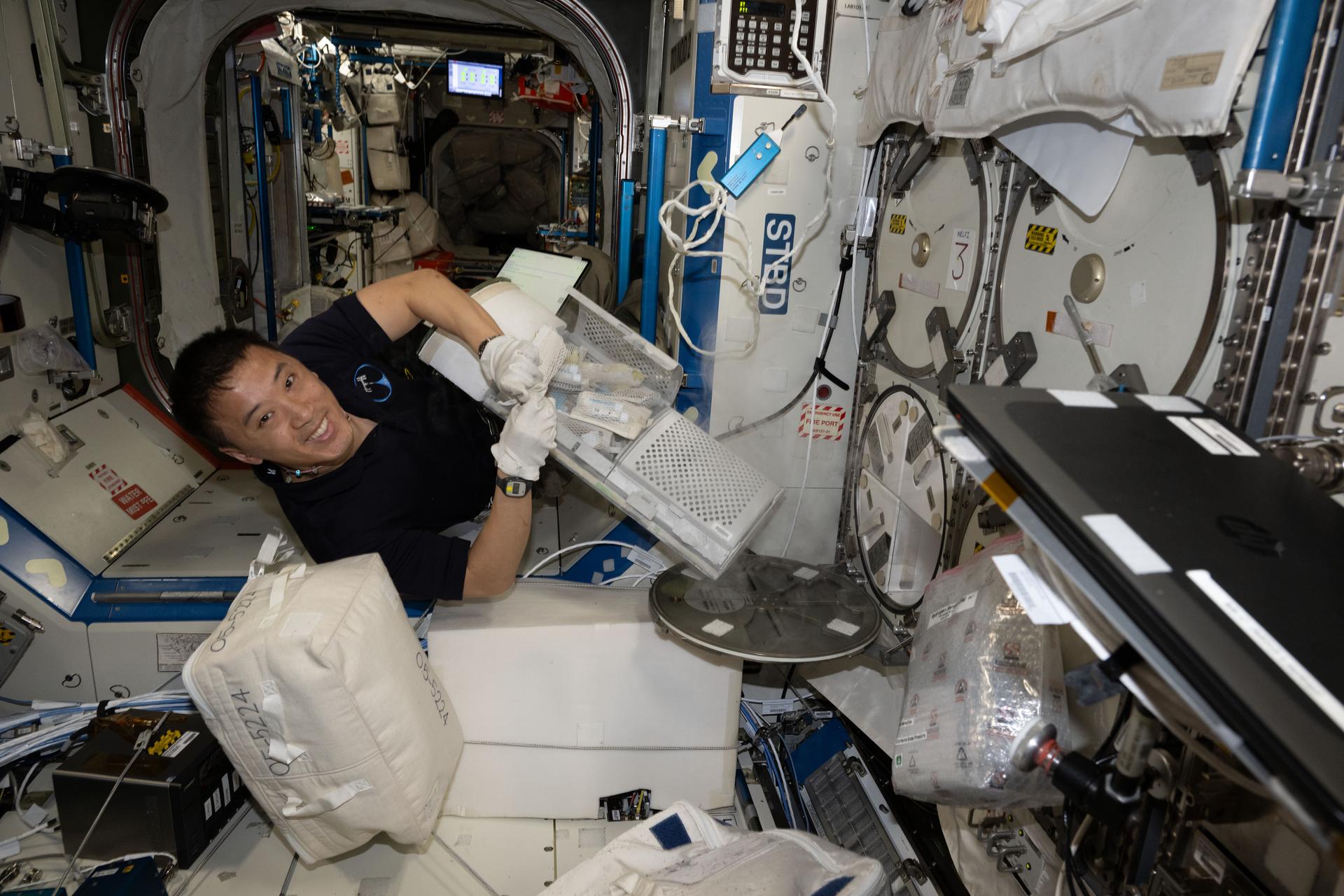 NASA astronaut and Expedition 73 Flight Engineer Jonny Kim stows research samples inside a cryogenic storage unit for installation inside a science freezer for preservation inside the International Space Station's Destiny laboratory module. Offically called the Minus Eighty-Degree Laboratory Freezer for ISS, or MELFI, the ultra-cold storage unit enables space biology research by preserving biological samples for analysis including blood, saliva, urine, microbes, and more.