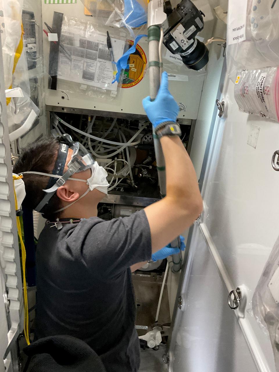 iss073e0136234 (June 9, 2025) --- NASA astronaut and Expedition 73 Flight Engineer Jonny Kim replaces orbital plumbing components inside the International Space Station's restroom, also called the waste and hygiene compartment, located in the Tranquility module.