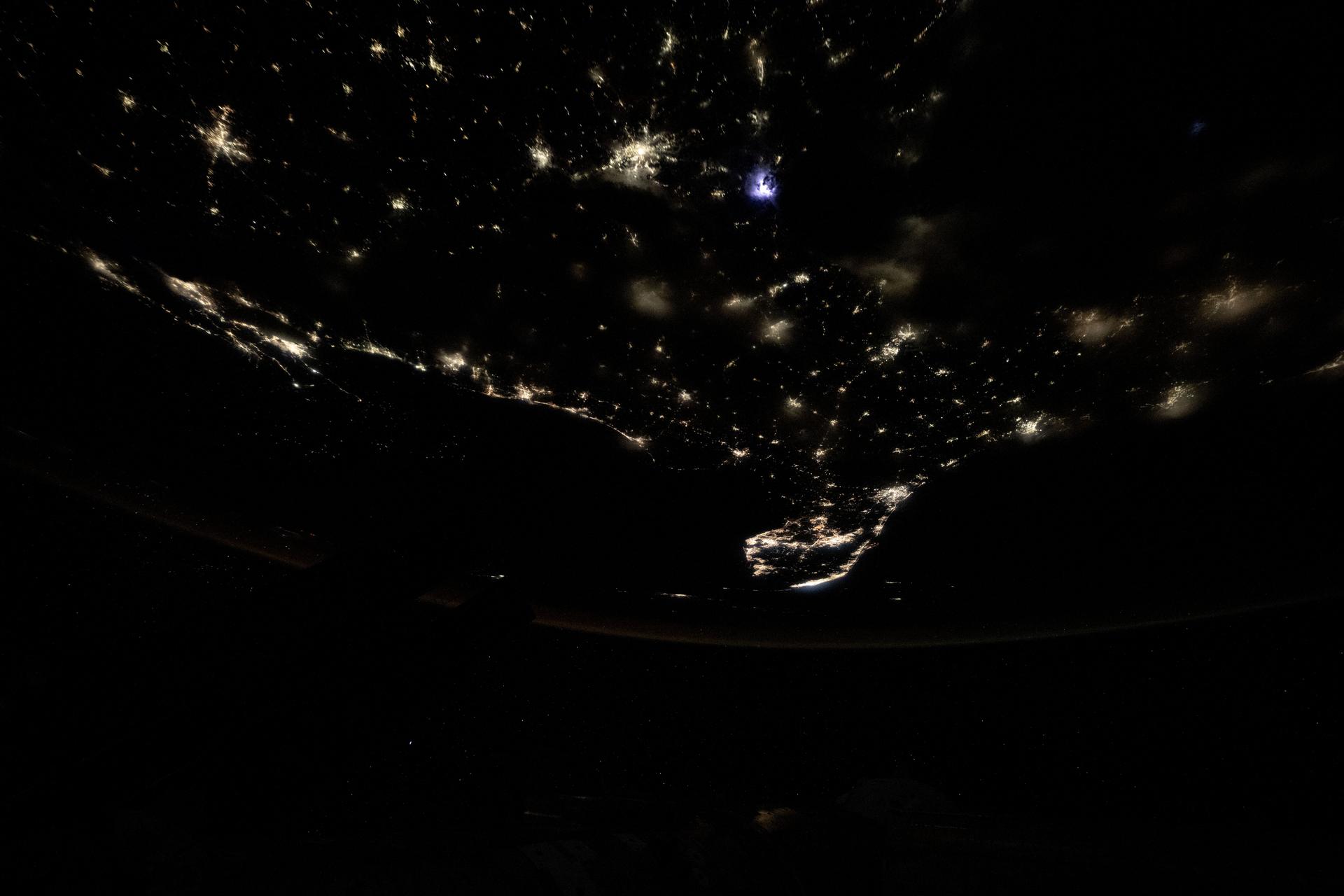 City lights dot the southern United States' landscape from Louisiana (upper left), to Florida (lower center), to South Carolina (right), in this photograph from the International Space Station as it orbited 260 miles above Georgia at approximately 12:59 a.m. local time.