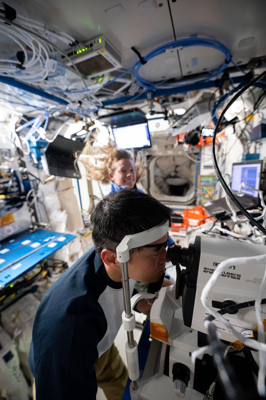 iss073e0175522 (6/9/2025) --- JAXA (Japan Aerospace Exploration Agency) astronaut Takuya Onishi, assisted by NASA astronaut Nichole Ayers, conducts an eye exam on the International Space Station using optical coherence tomography. This technology uses reflected light to produce 3D images of the retina, nerve fibers, and other eye structures and layers. Spaceflight can cause changes to eye structure and vision, so scientists monitor the eye health of crew members throughout their missions.