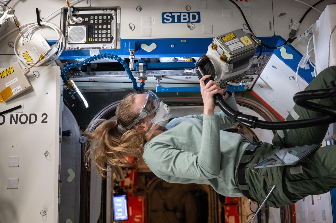 iss073e0176256 (June 11, 2025) --- NASA astronaut and Expedition 73 Flight Engineer Nichole Ayers inspects and cleans ventilation fans inside the International Space Station's Destiny laboratory module. The fans control the circulation of airflow between modules aboard the orbital outpost.