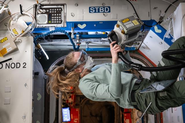 NASA image: NASA astronaut Nichole Ayers inspects and cleans ventilation fans