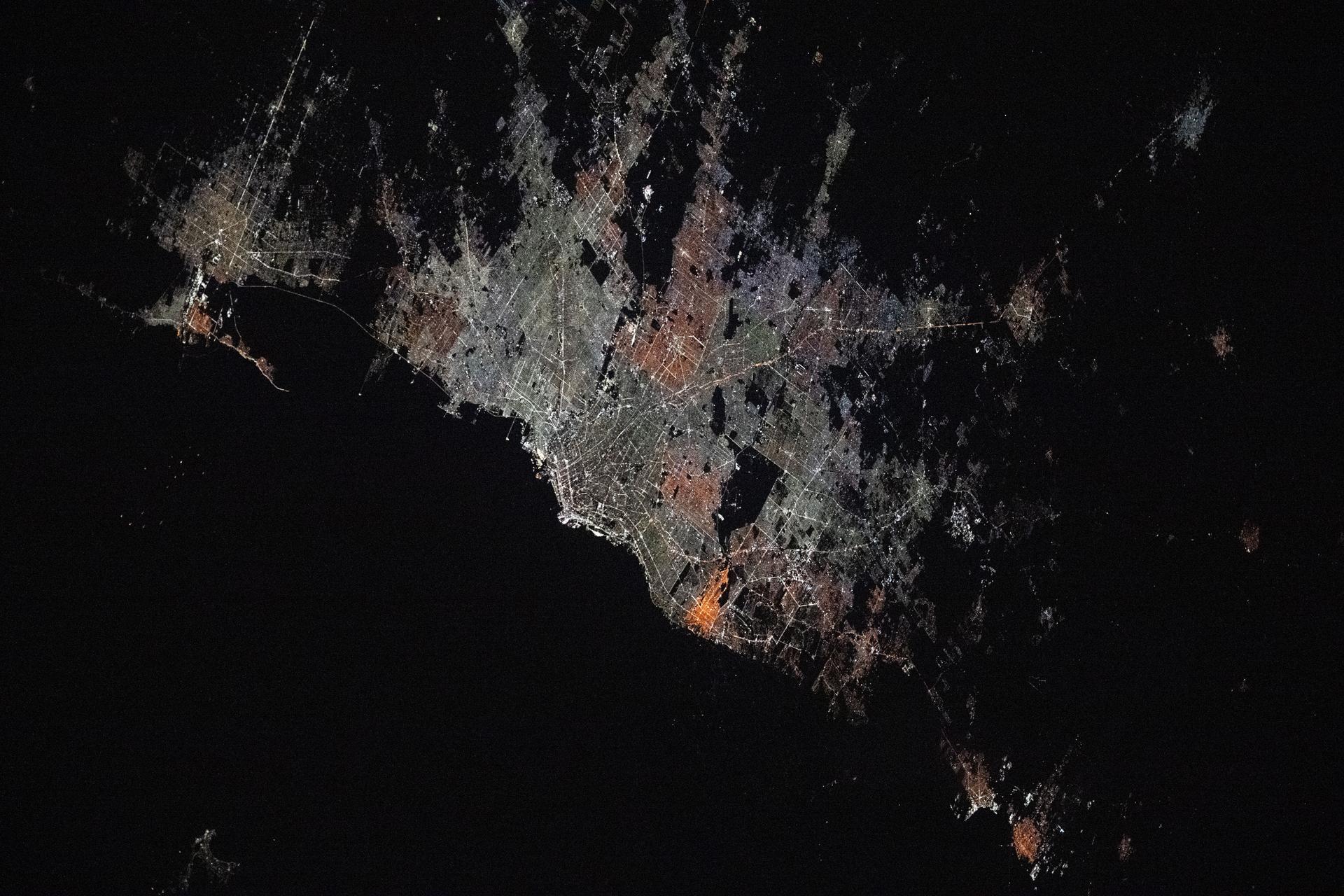 The Argentinian cities of La Plata (top left) and Buenos Aires and their surrounding suburbs with a combined population of about 13.66 million are pictured at approximately 4:43 a.m. local time from the International Space Station as it orbited 267 miles above.